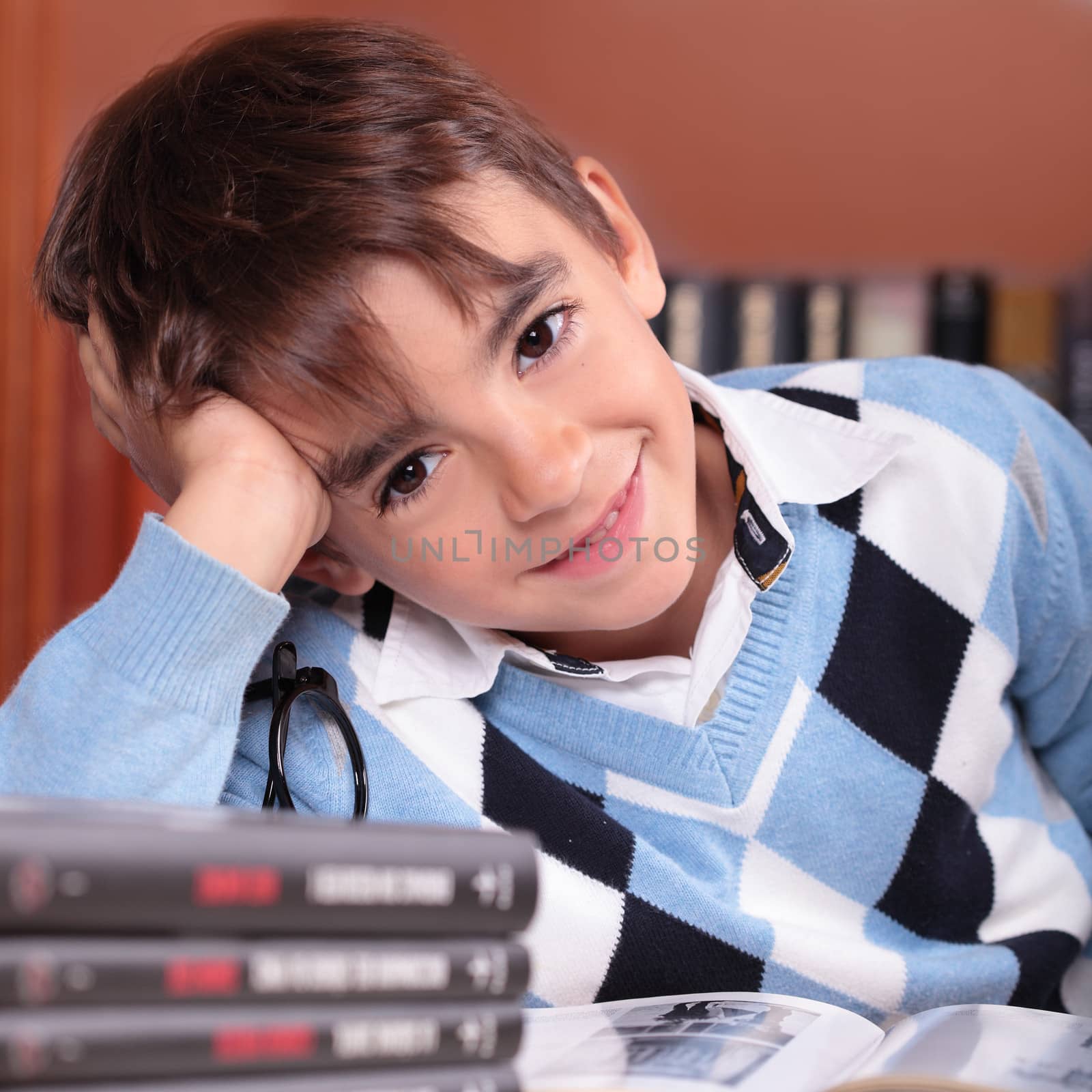 portrait of a boy smiling in a library