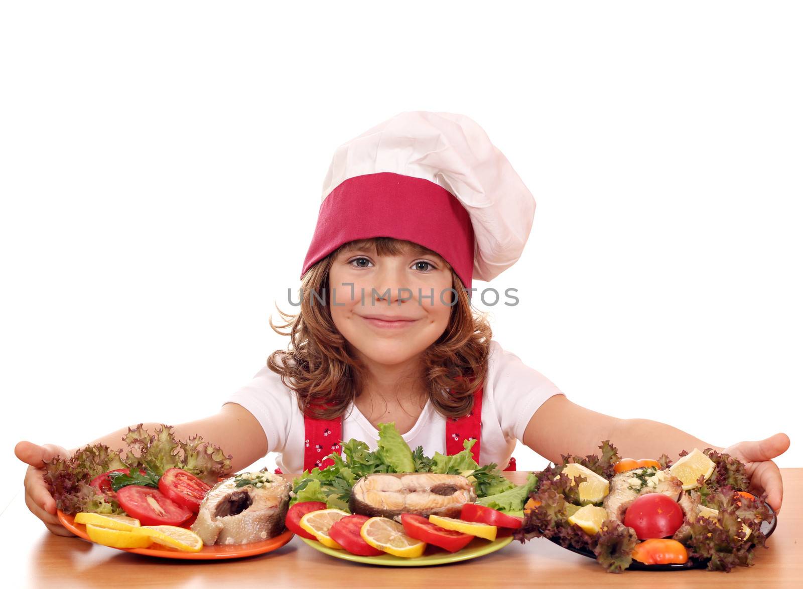 beautiful little girl cook with prepared salmon seafood by goce