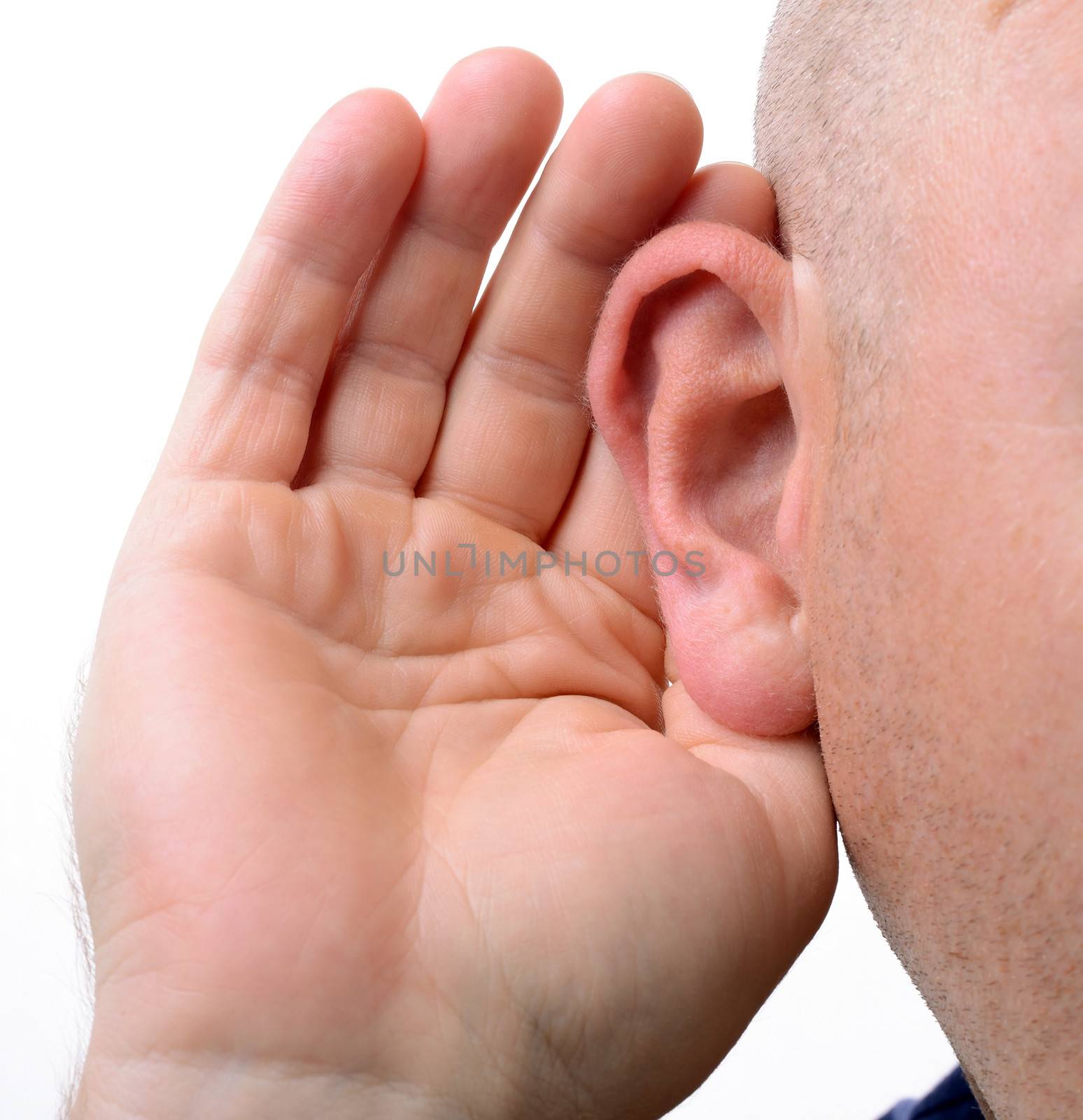 close up of a hand cupping an ear to hear better isolated on white