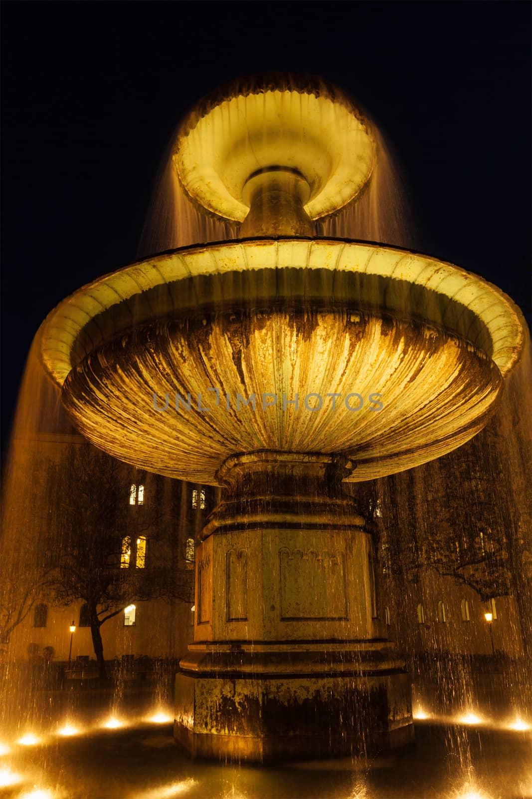 Fountain in the Geschwister-Scholl-Platz in the evening. Munich, Bavaria, Germany