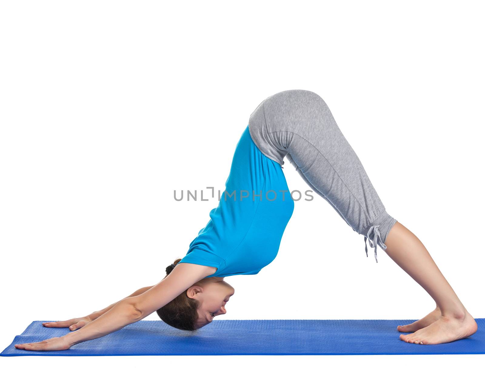 Yoga - young beautiful woman yoga instructor doing downward facing dog pose (adho mukha svanasana) exercise isolated on white background