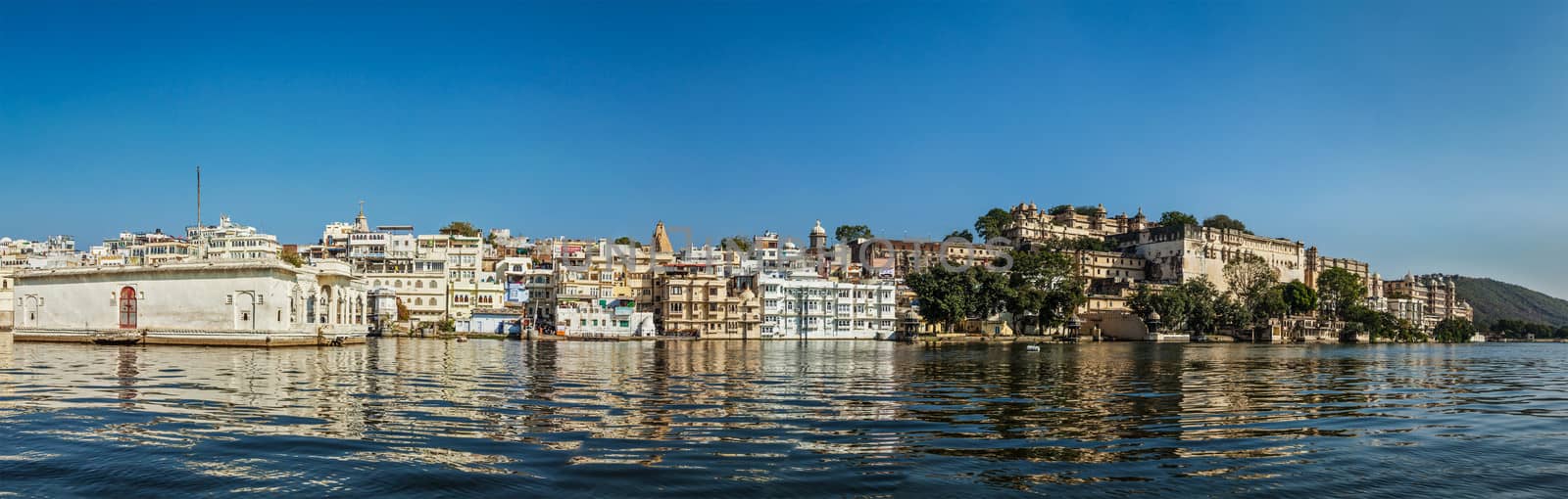 India luxury tourism concept background - panorama of Udaipur City Palace from Lake Pichola. Udaipur, India