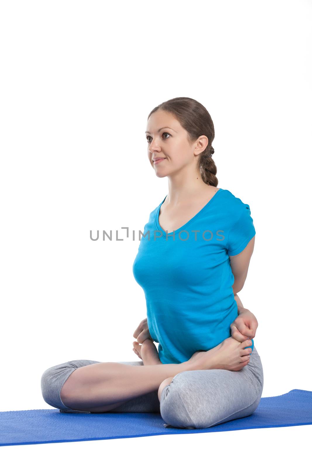 Yoga - young beautiful woman  yoga instructor doing bound lotus pose (Baddha Padmasana) exercise isolated on white background