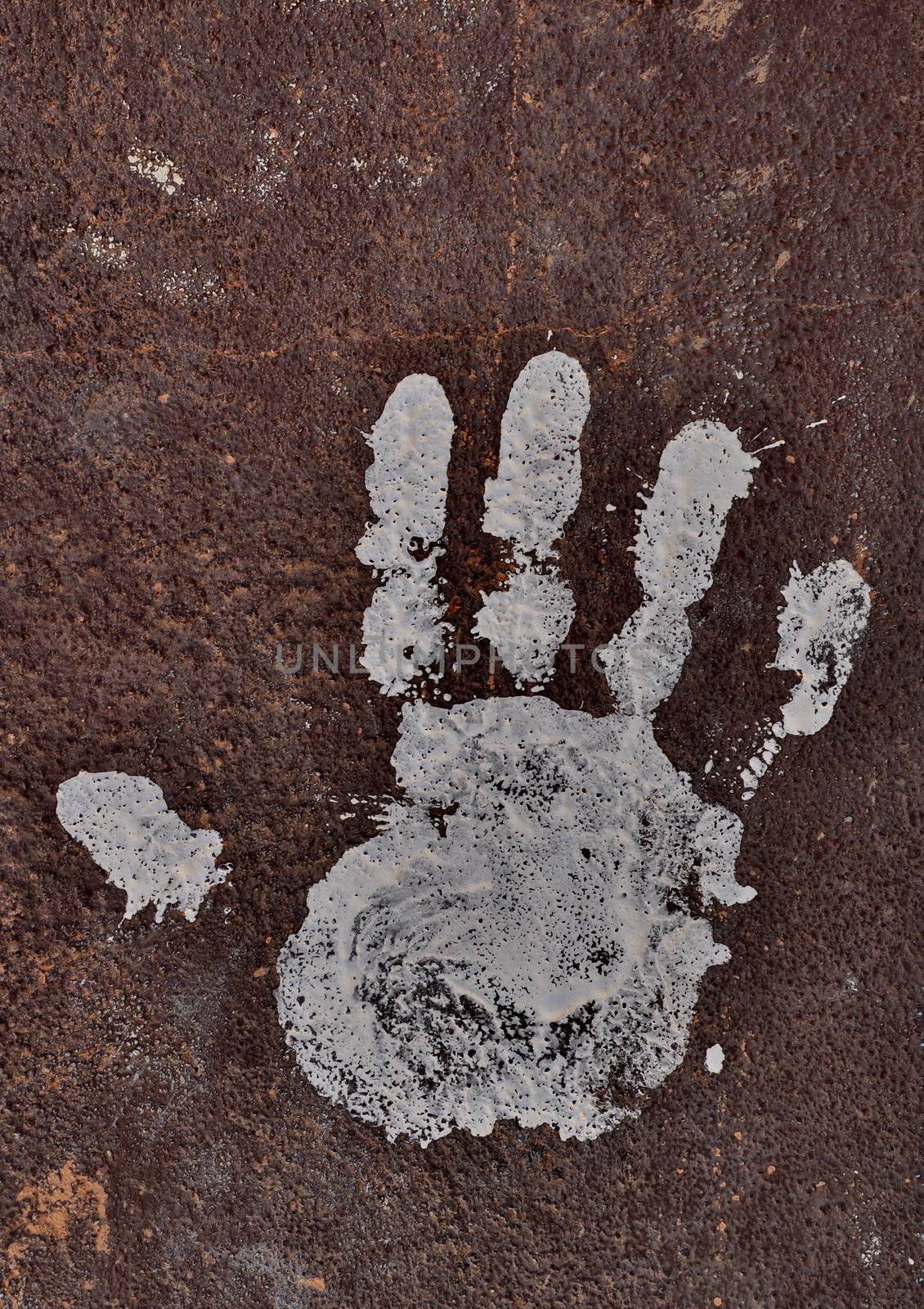 White handprint on rusty surface by anderm