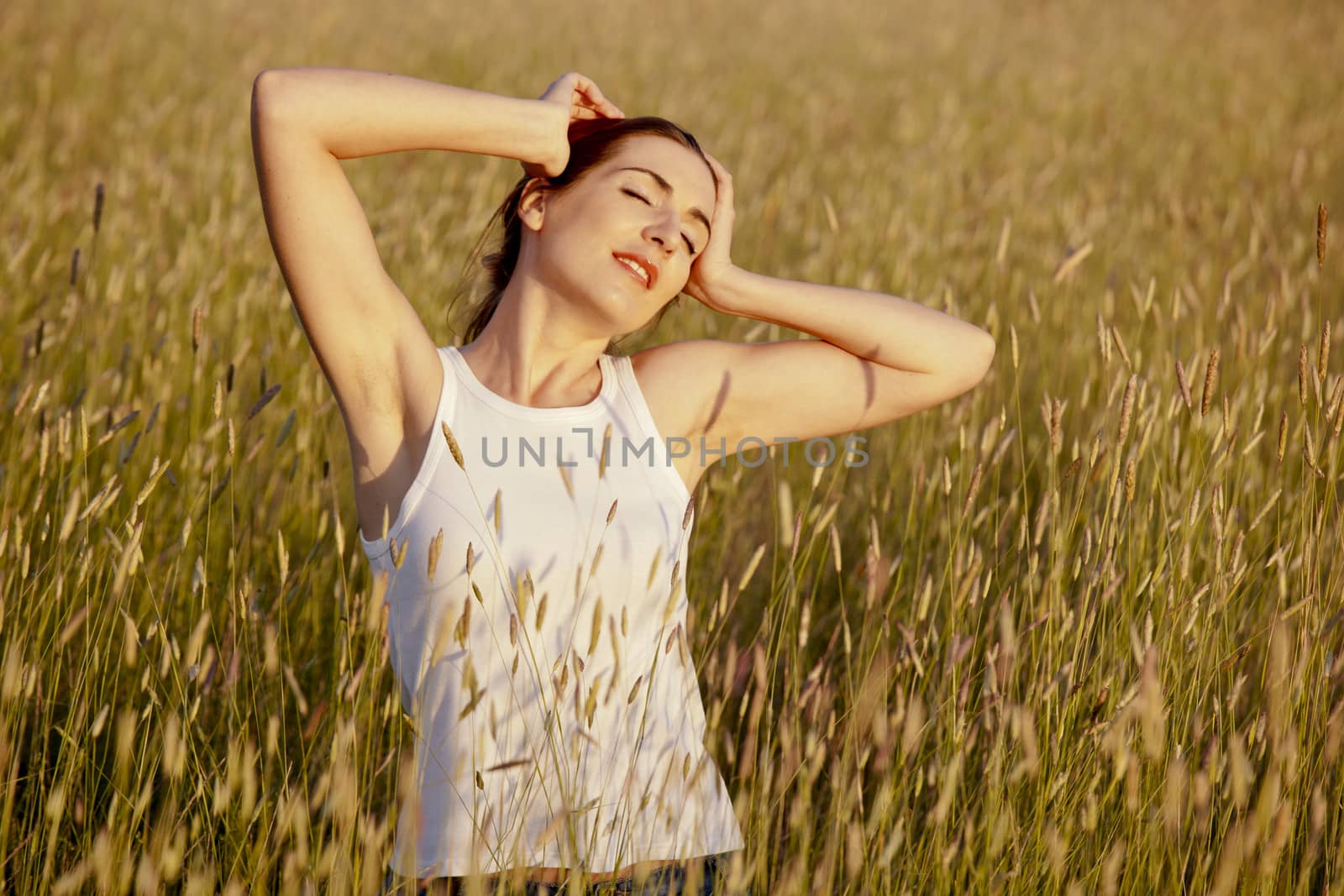 Outdoor portrait of a woman on a meadow releaxing