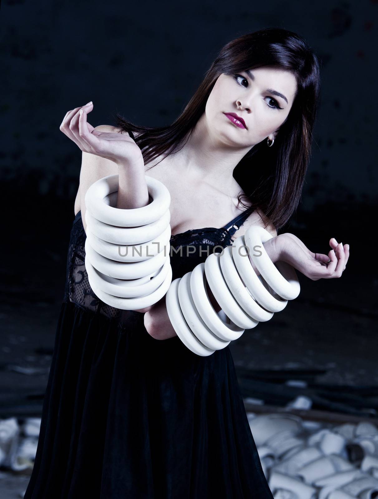 Fashion photoshoot with  a beautifulyoung woman holding pieces of porcelain