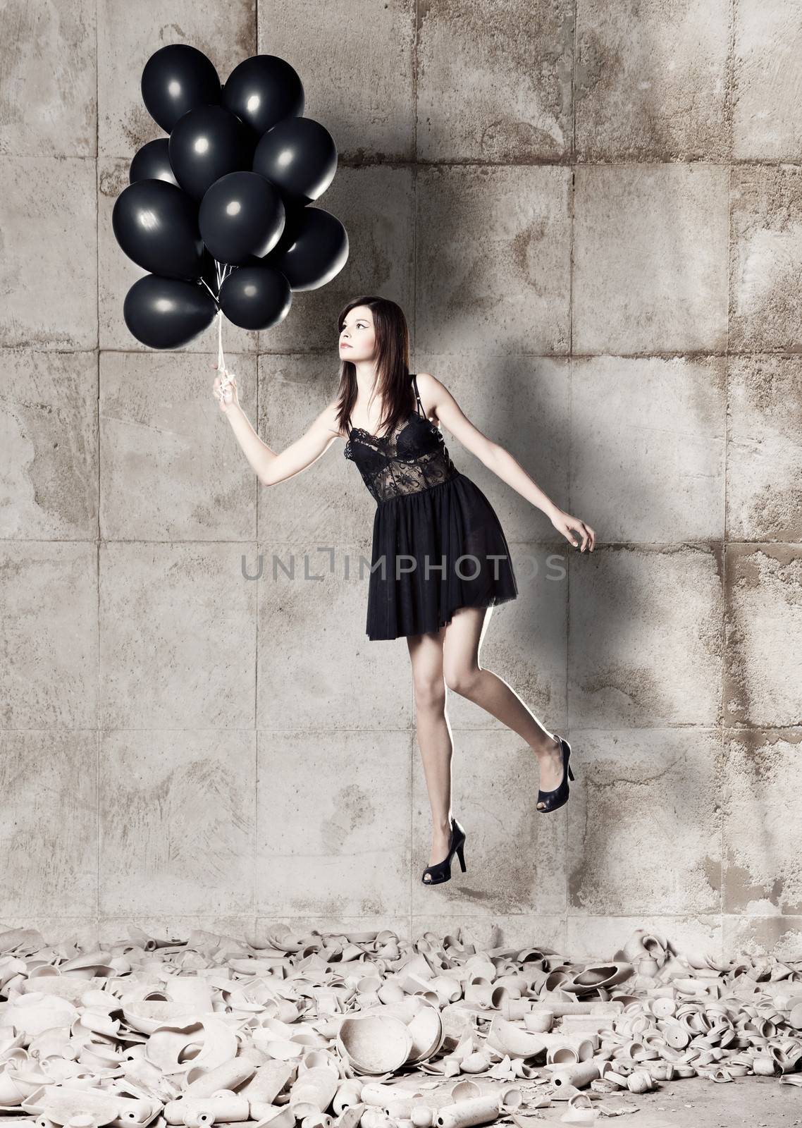 Fashion photoshoot with  a beautiful young woman holding balloons