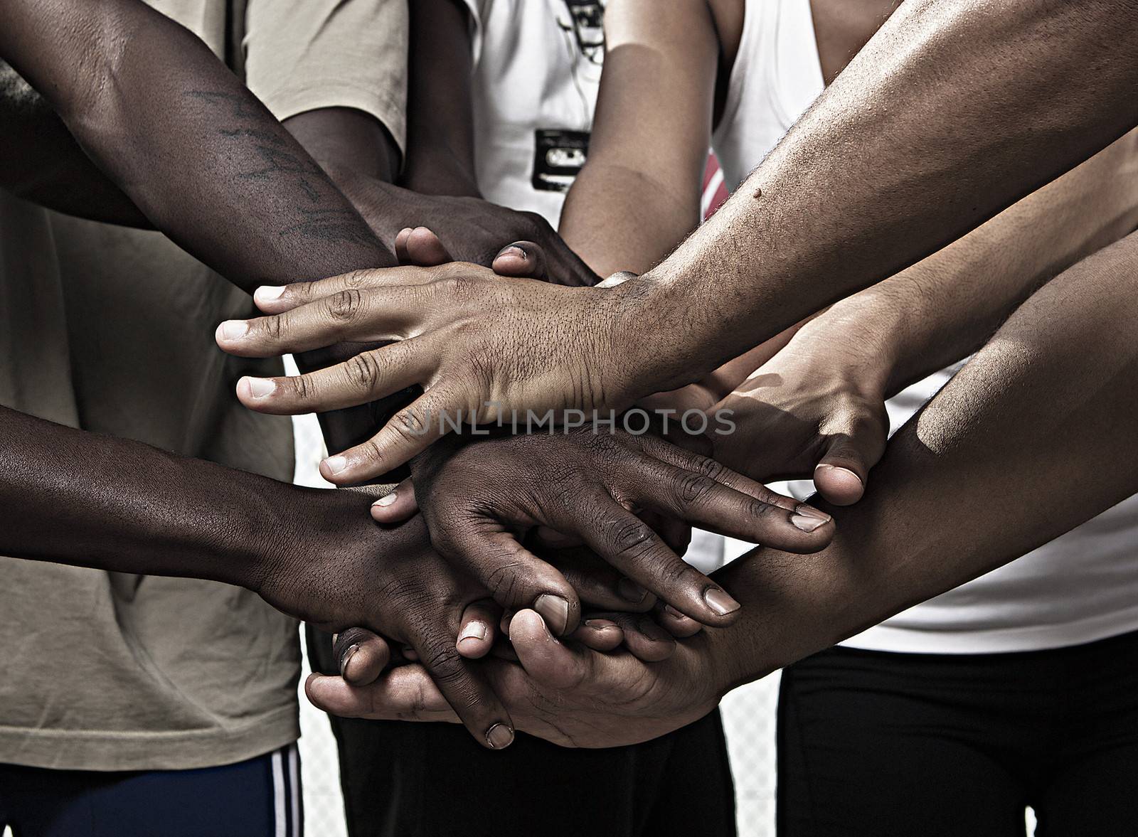 Closeup portrait of group with mixed race people with hands together