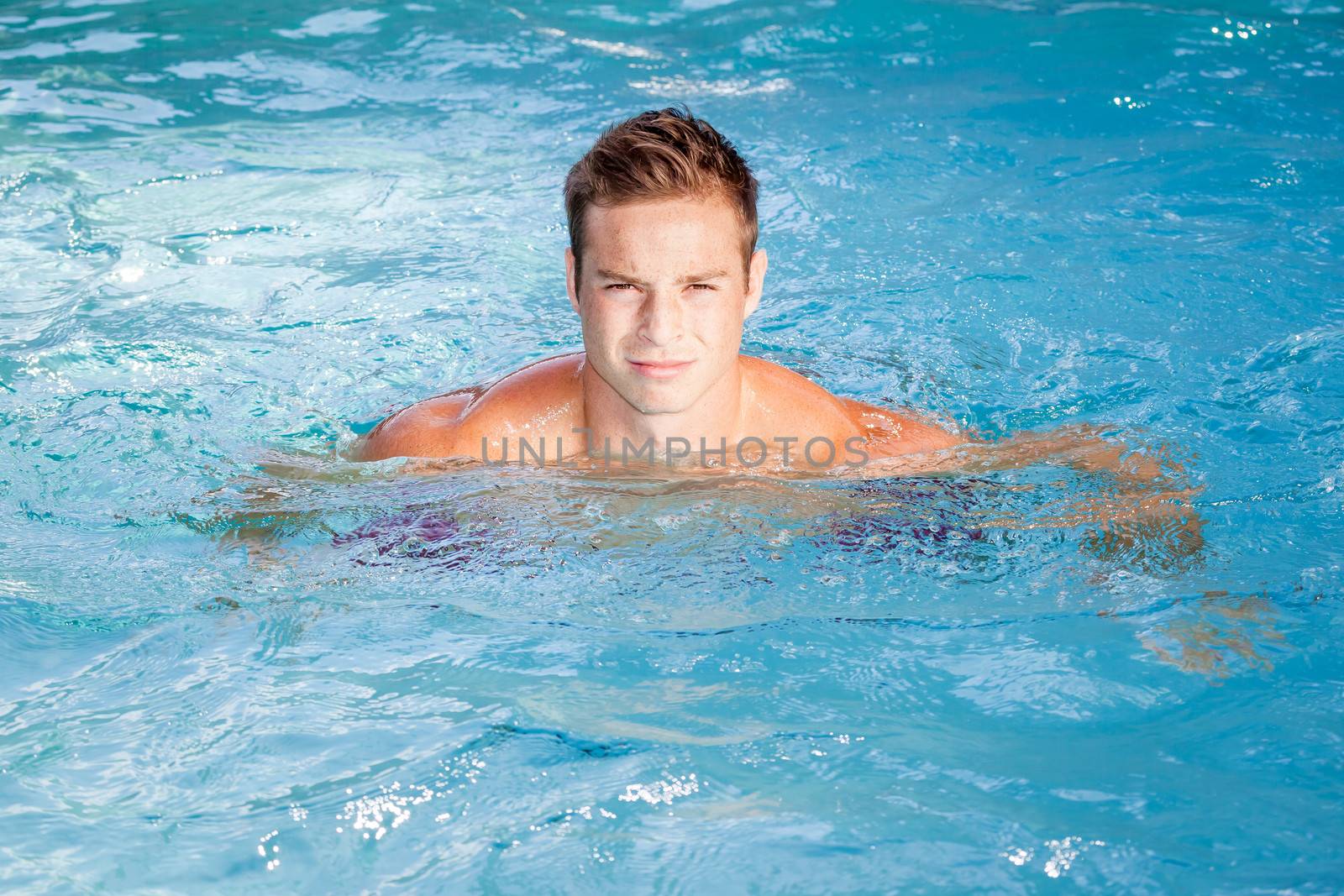 An image of a beautiful man swimming in the pool