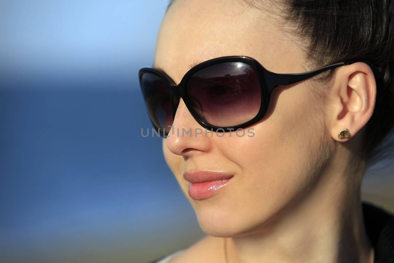 The girl with smile in solar glasses