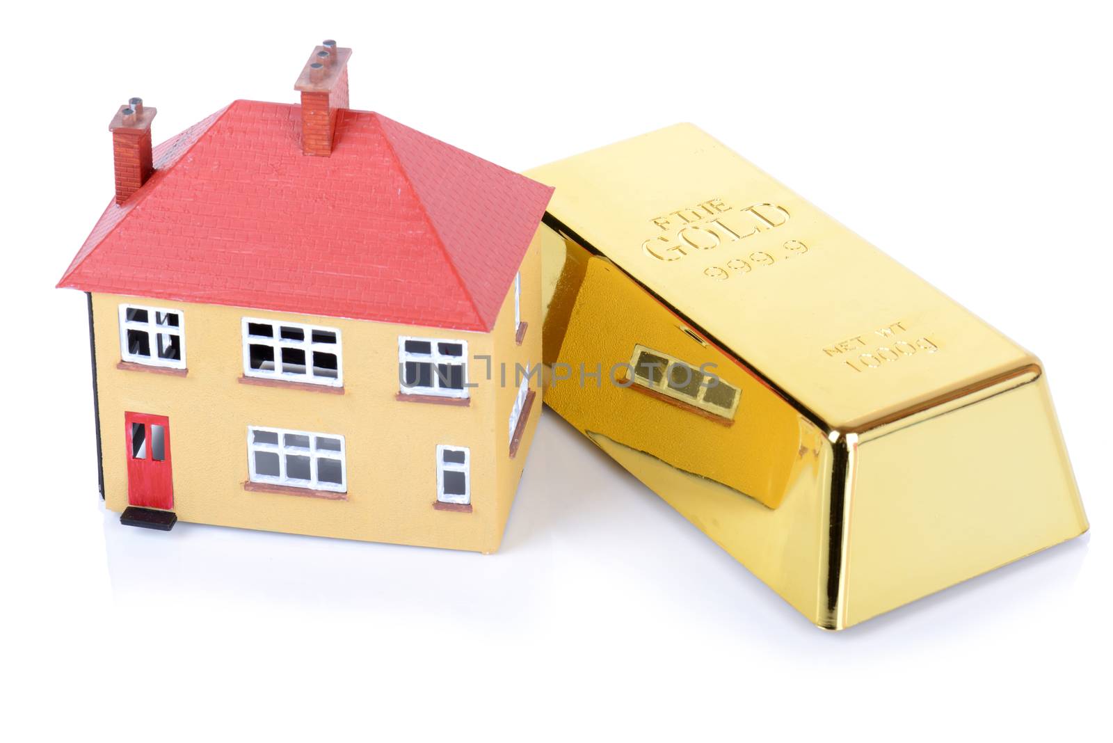 gold bar and house concept of real estate investment