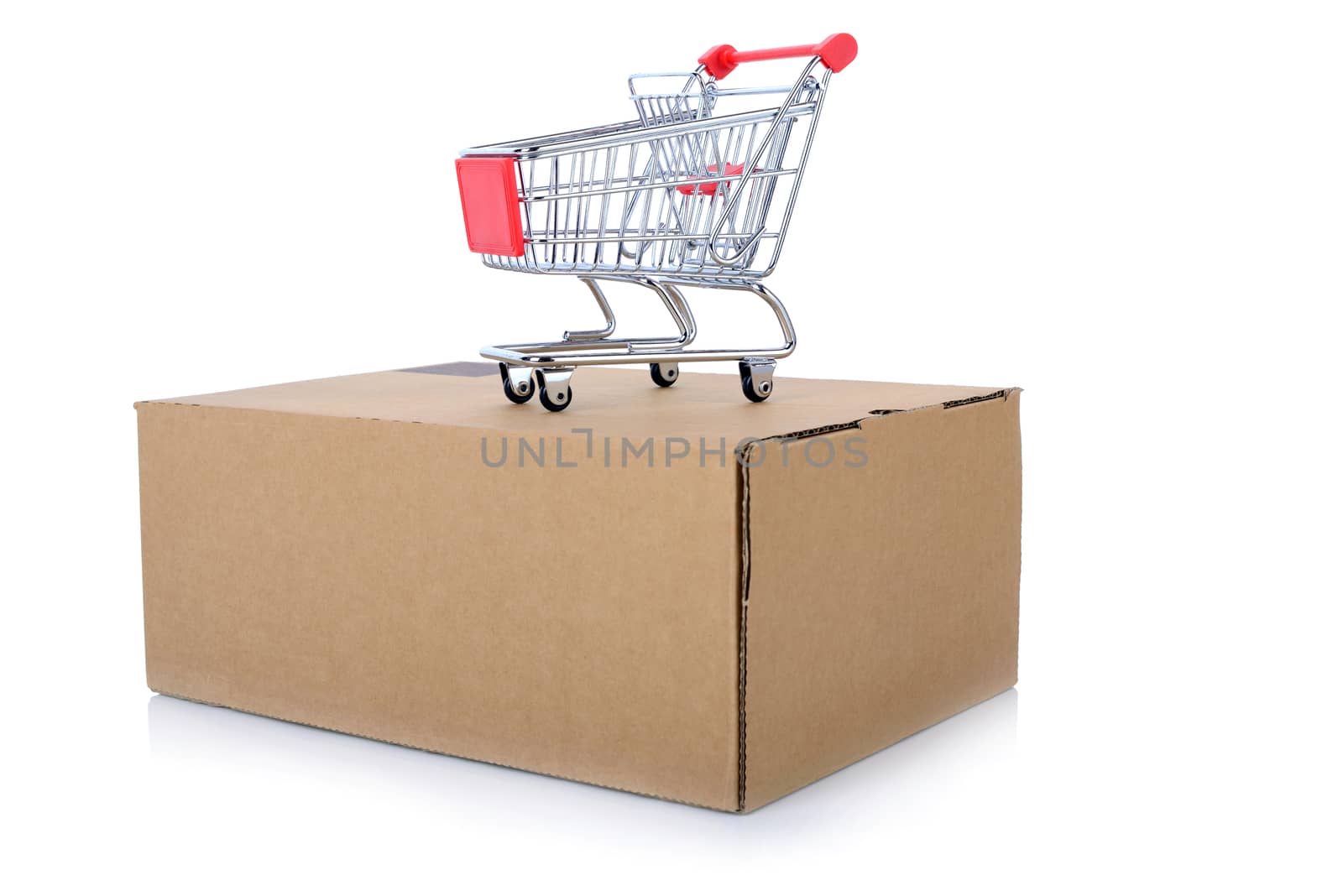concept of internet shopping of a push cart isolated on top of a package