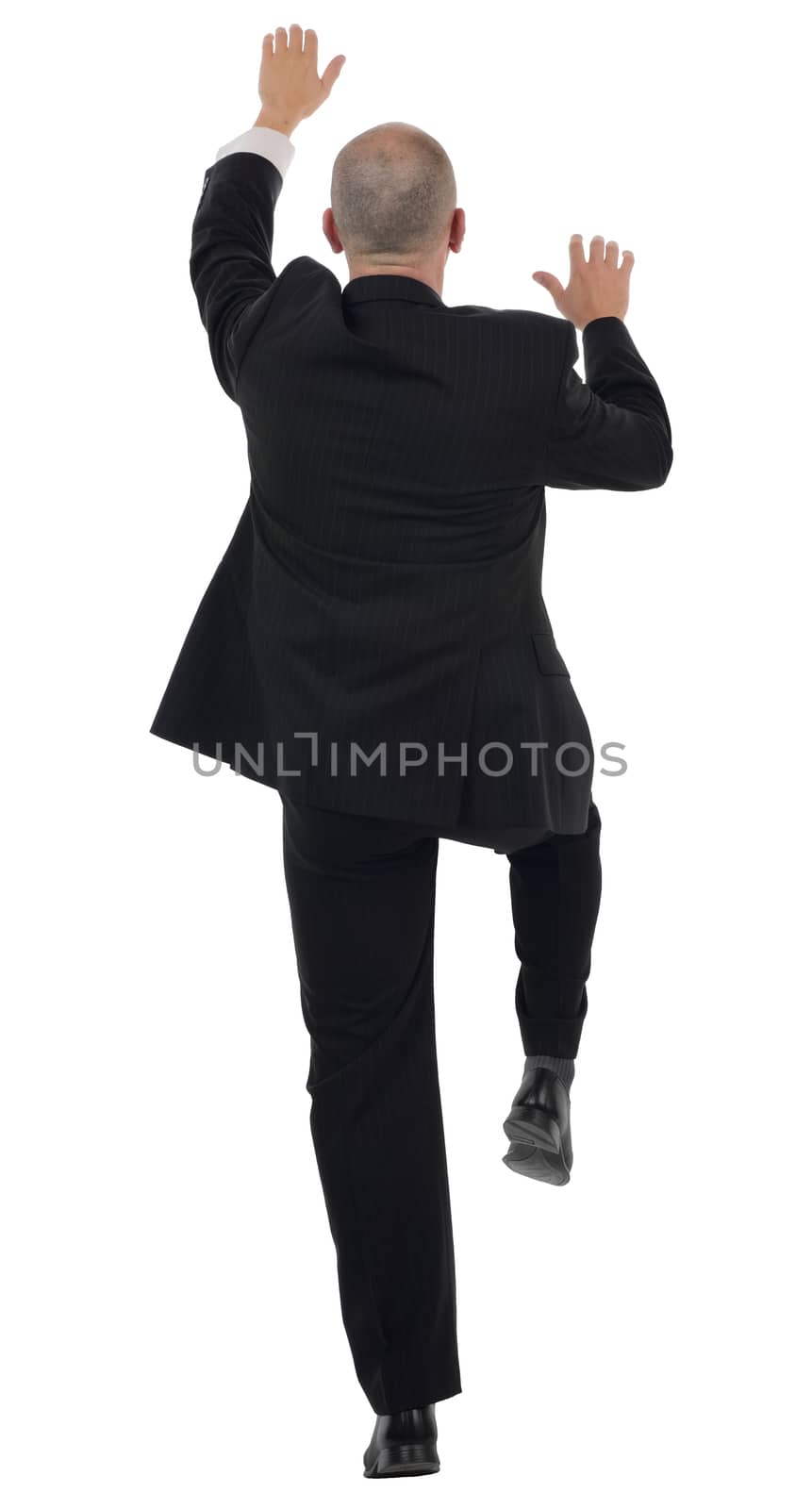 rear view of a businessman climbing isolated on a white background