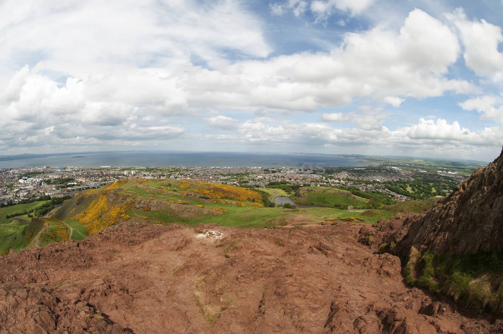 Arthur's Seat is the main peak of the group of hills which form most of Holyrood Park. It is situated in the centre of the city of Edinburgh, about a mile to the east of Edinburgh Castle. The hill rises above the city to a height of 250.5 m (822 ft), provides excellent panoramic views of the city, is relatively easy to climb, and is popular for hillwalking.
