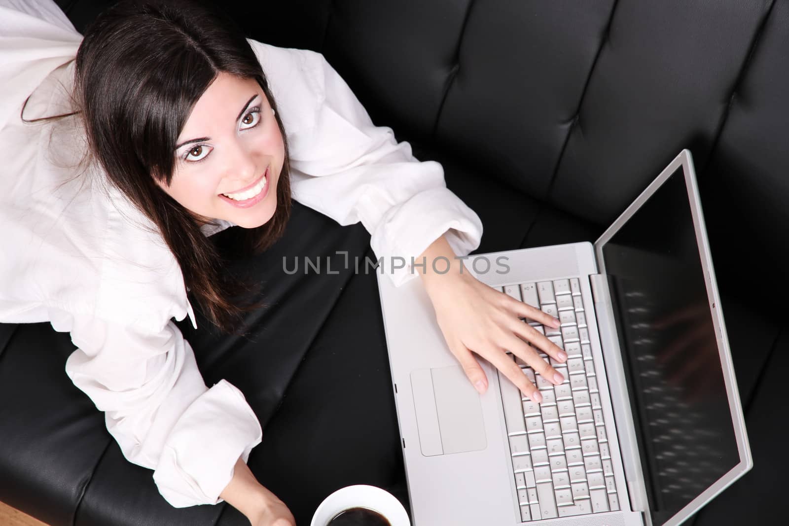 A young woman surfing on the Internet with a Laptop.  