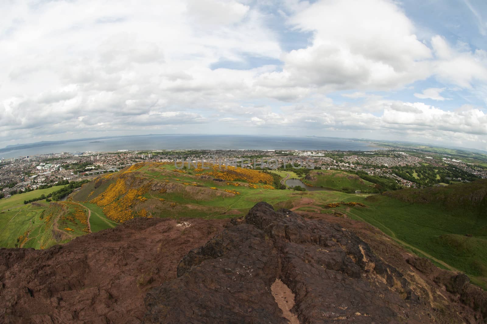 Arthur's Seat is the main peak of the group of hills which form most of Holyrood Park. It is situated in the centre of the city of Edinburgh, about a mile to the east of Edinburgh Castle. The hill rises above the city to a height of 250.5 m (822 ft), provides excellent panoramic views of the city, is relatively easy to climb, and is popular for hillwalking.