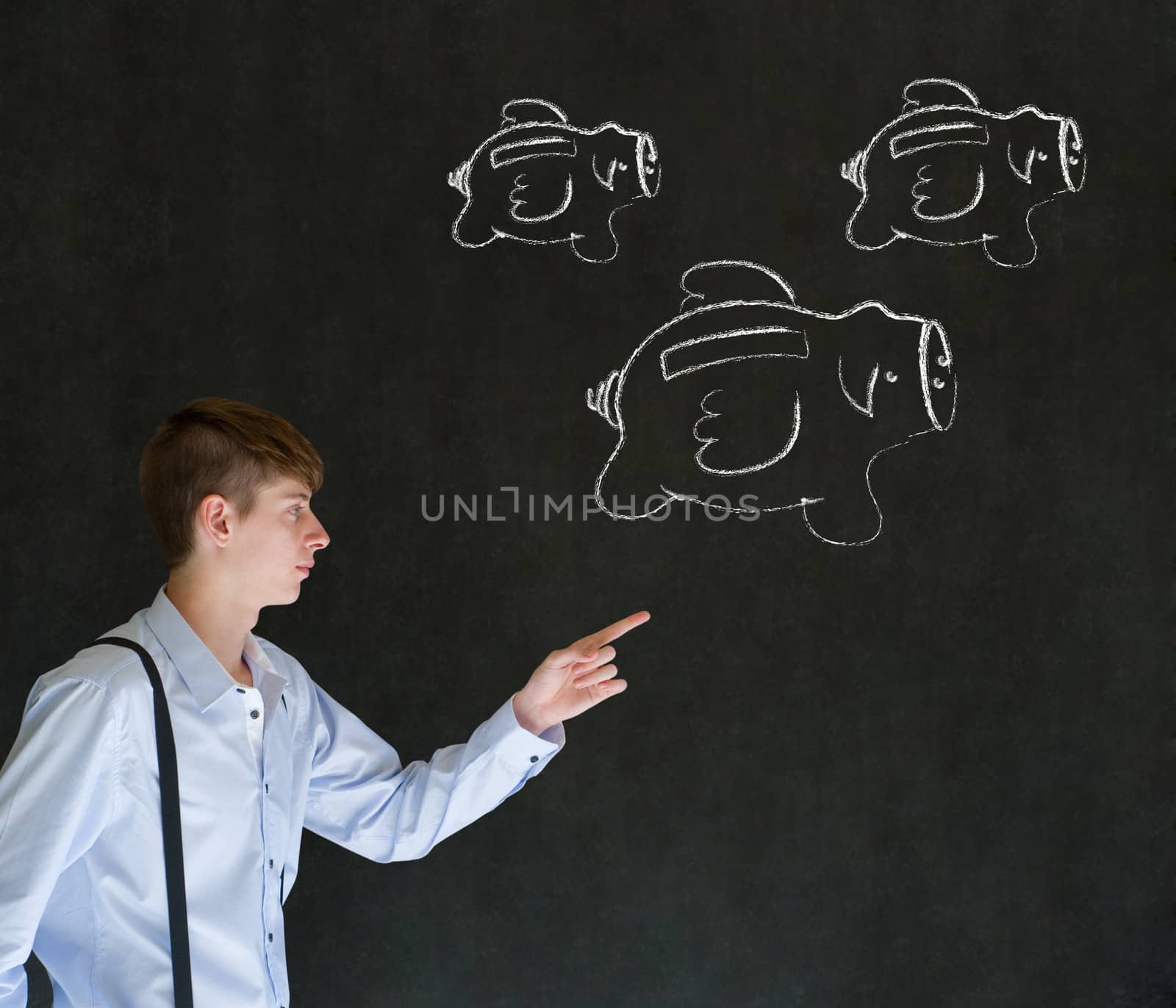 Businessman pointing at flying money piggy banks in chalk on blackboard background
