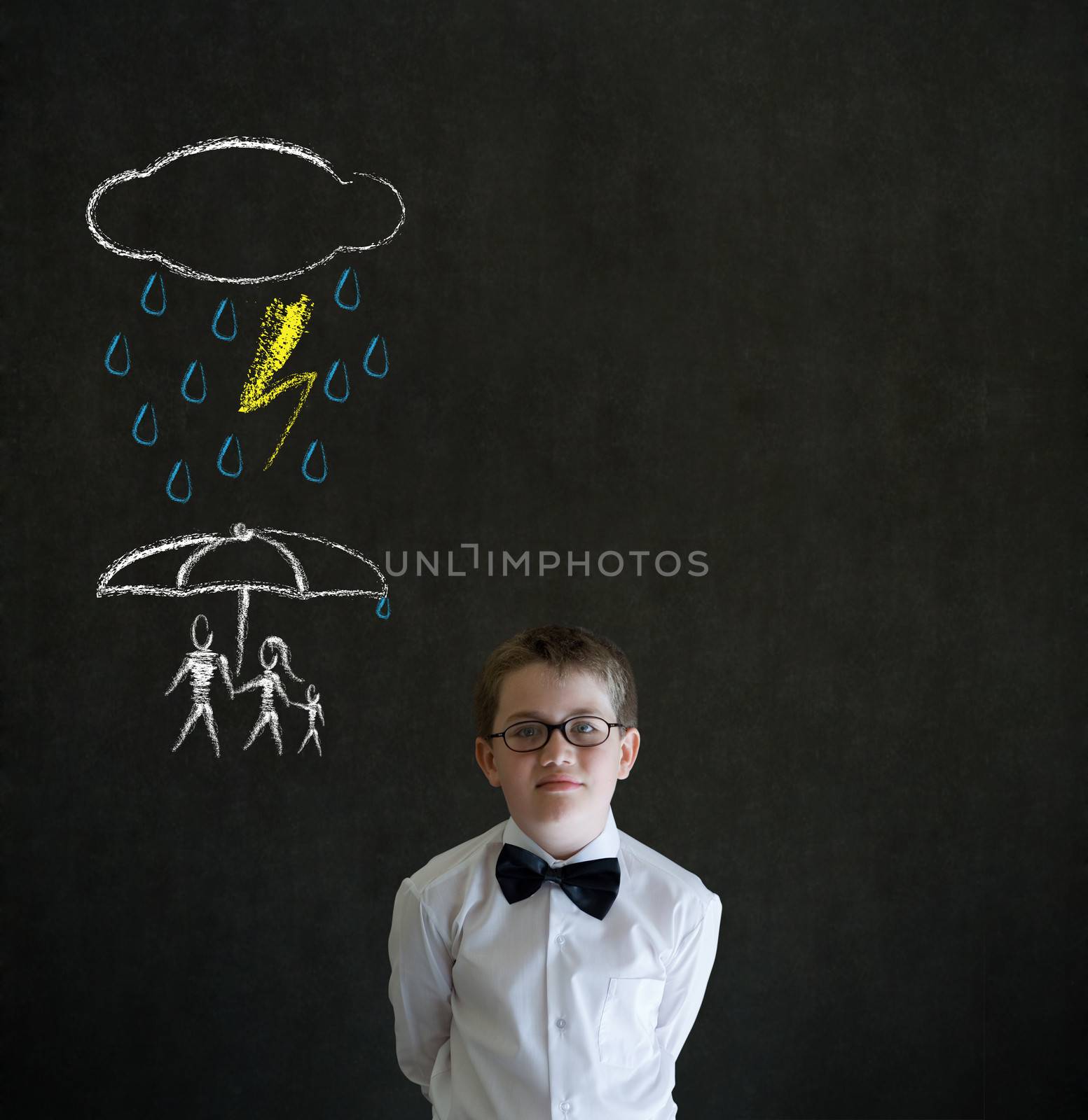Thinking boy dressed up as business man thinking about protecting family from natural disaster on blackboard background