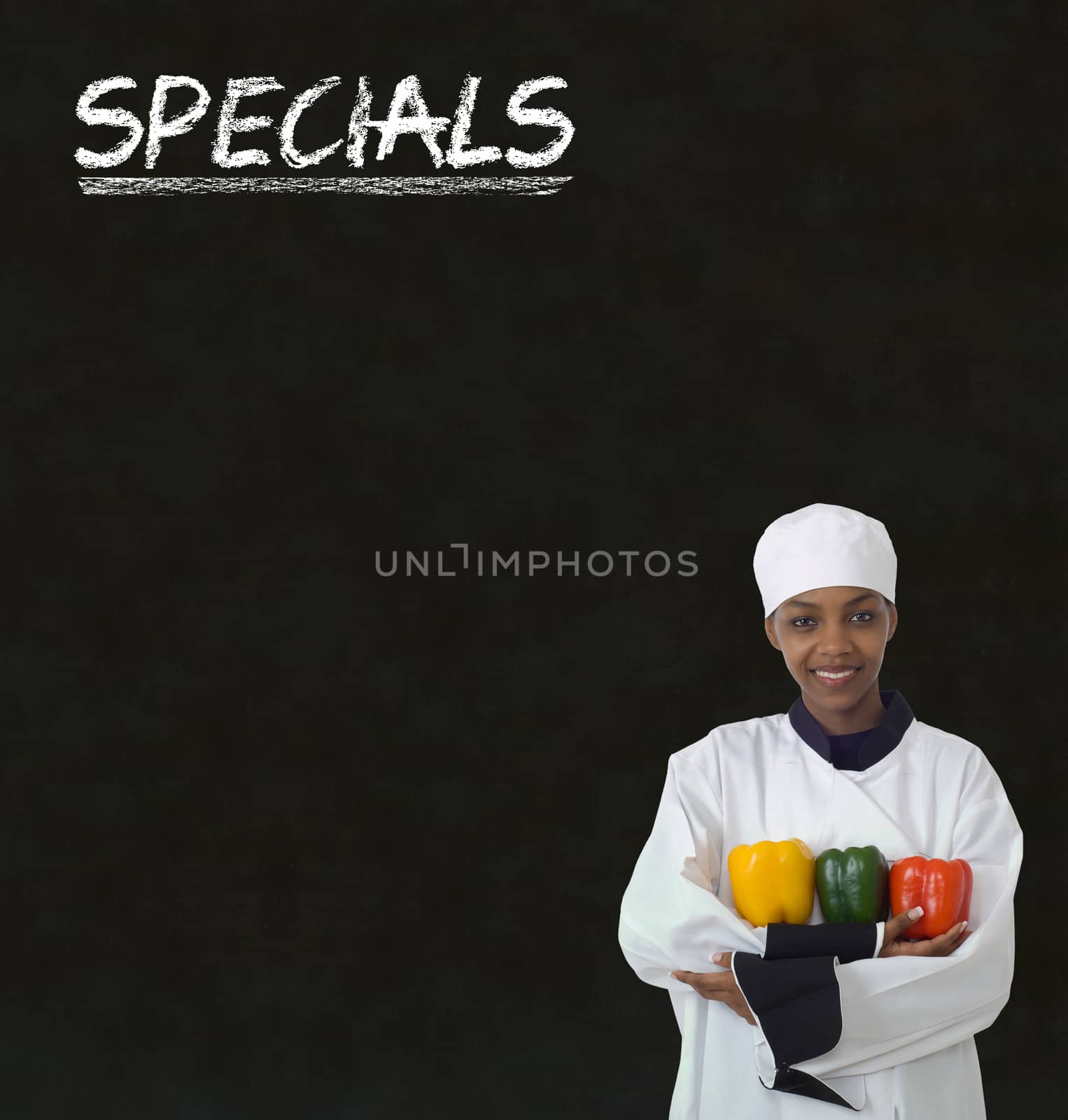 African American woman chef with chalk specials sign on blackboard background by alistaircotton