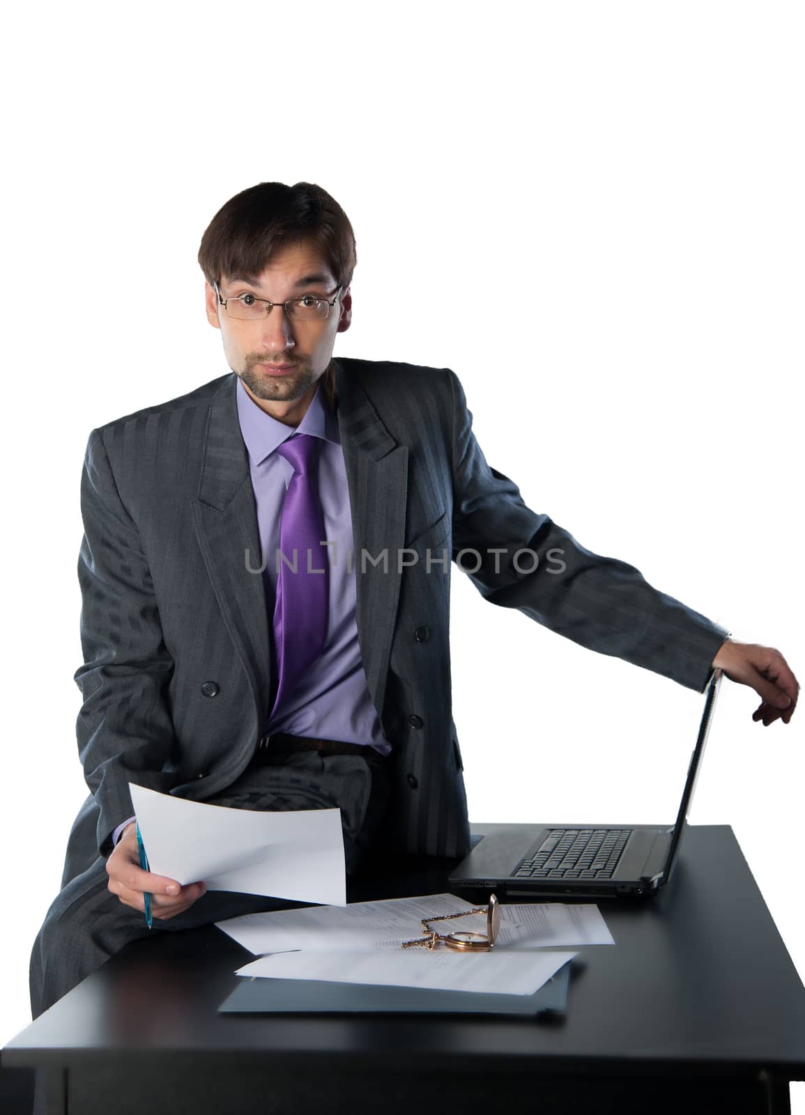 business man sitting on a desk with a laptop