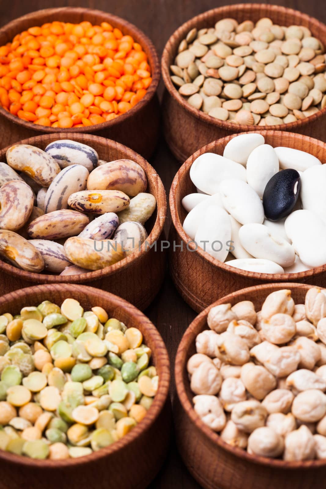 Different types of beans in wooden bowls