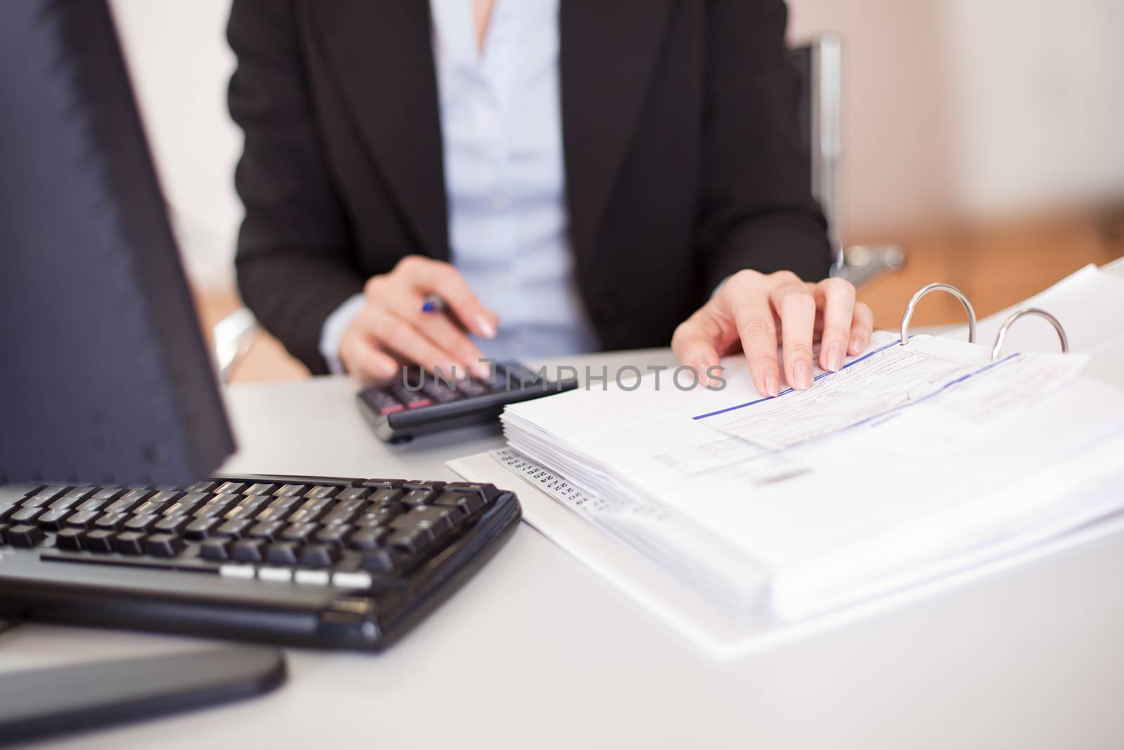 Closeup of a businesswoman doing finances in the office