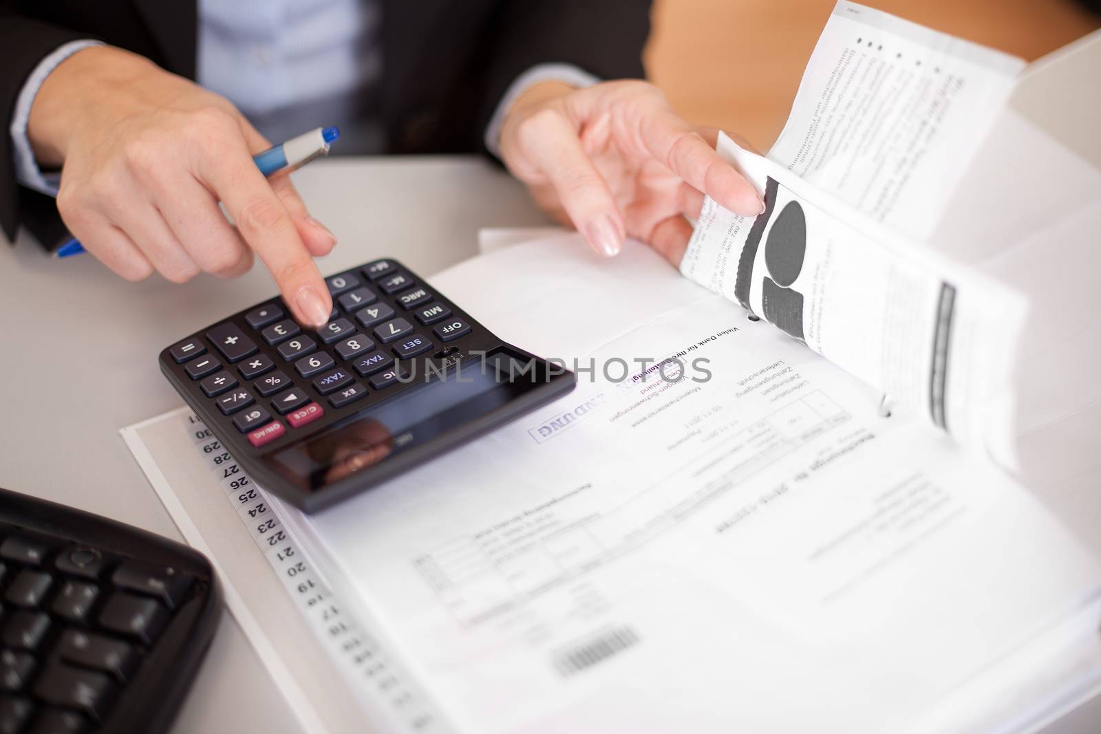 Beautiful businesswoman doing finances in the office