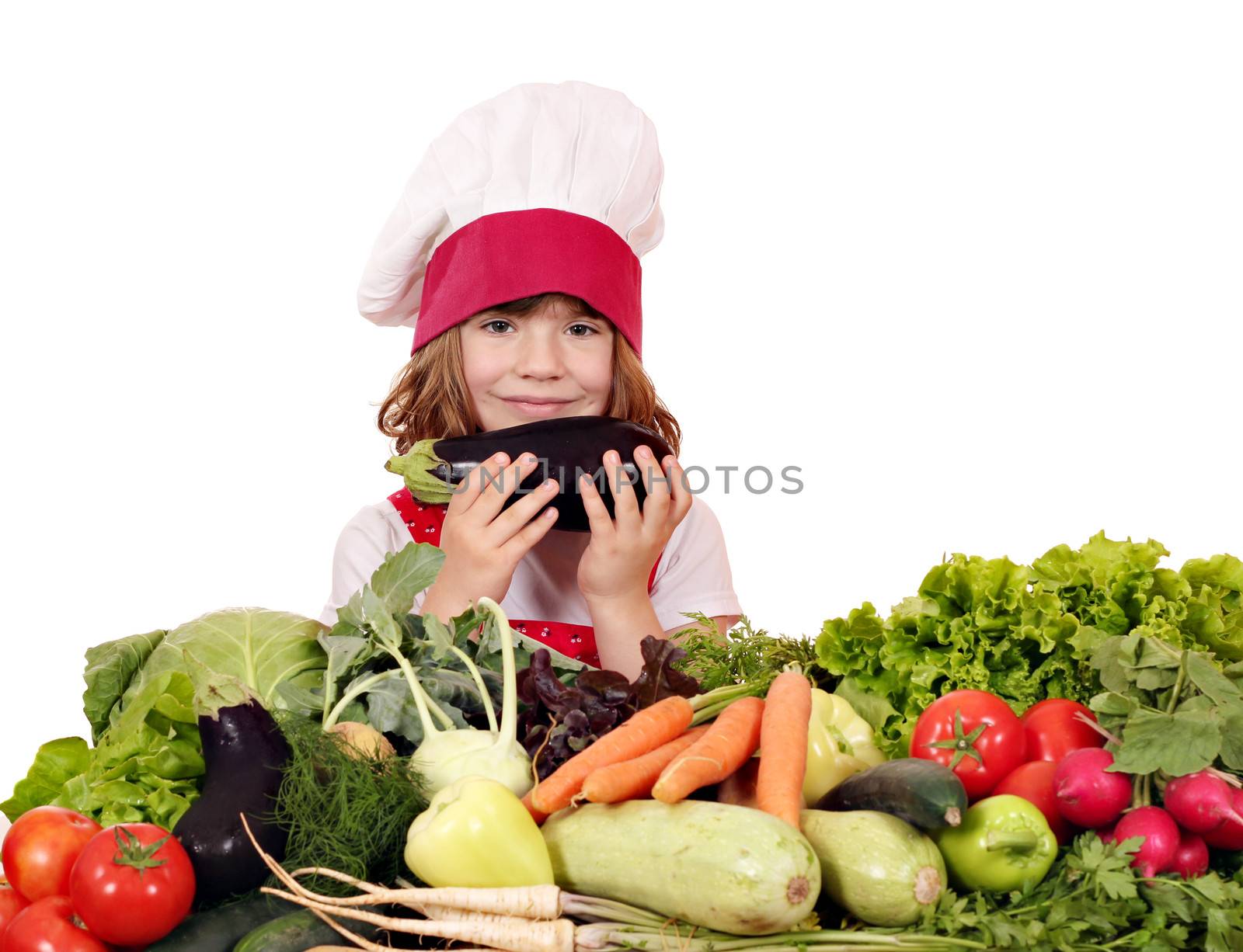 little girl cook with aubergine and vegetables by goce