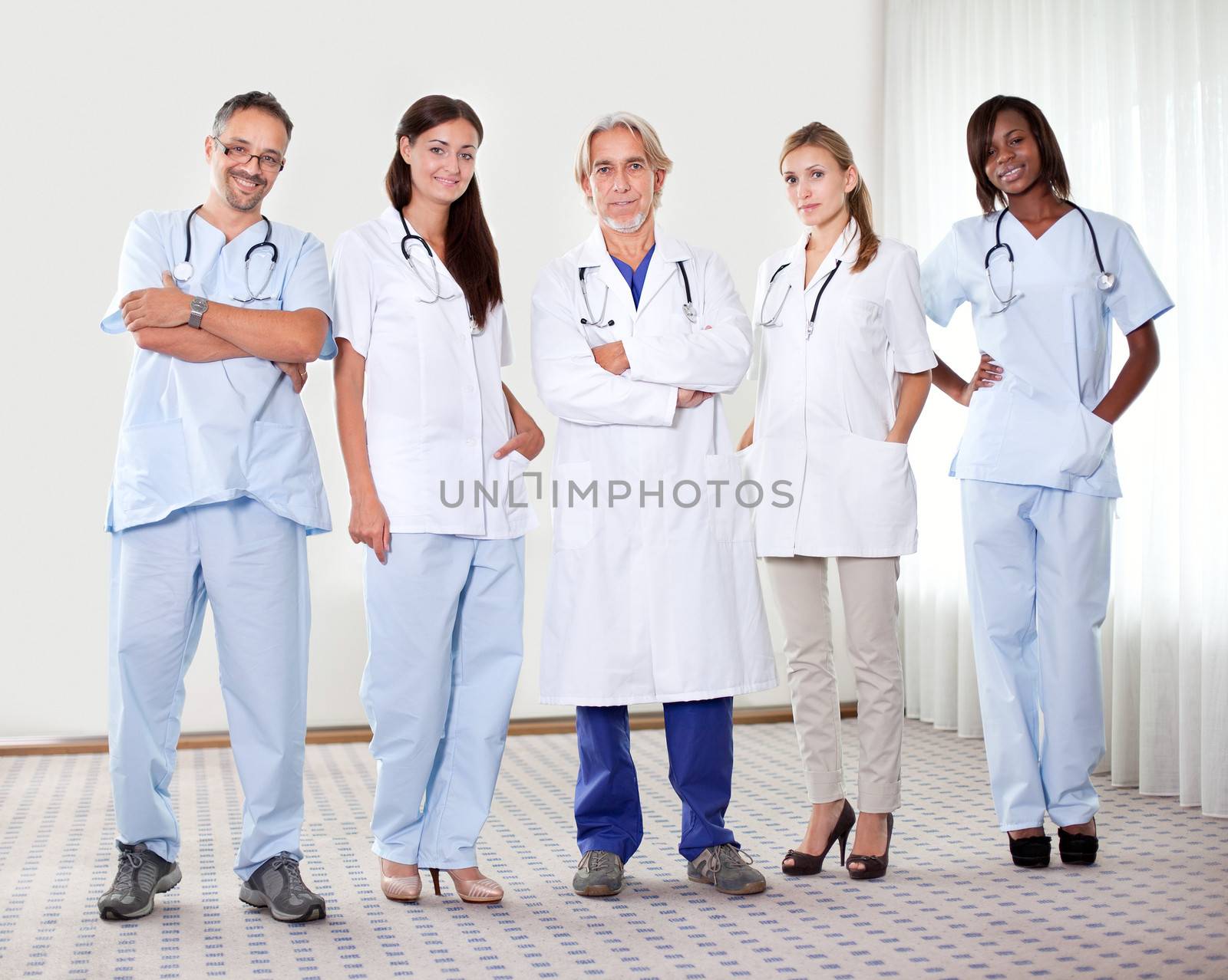 Successful happy group of doctors with stethoscope at the hospital