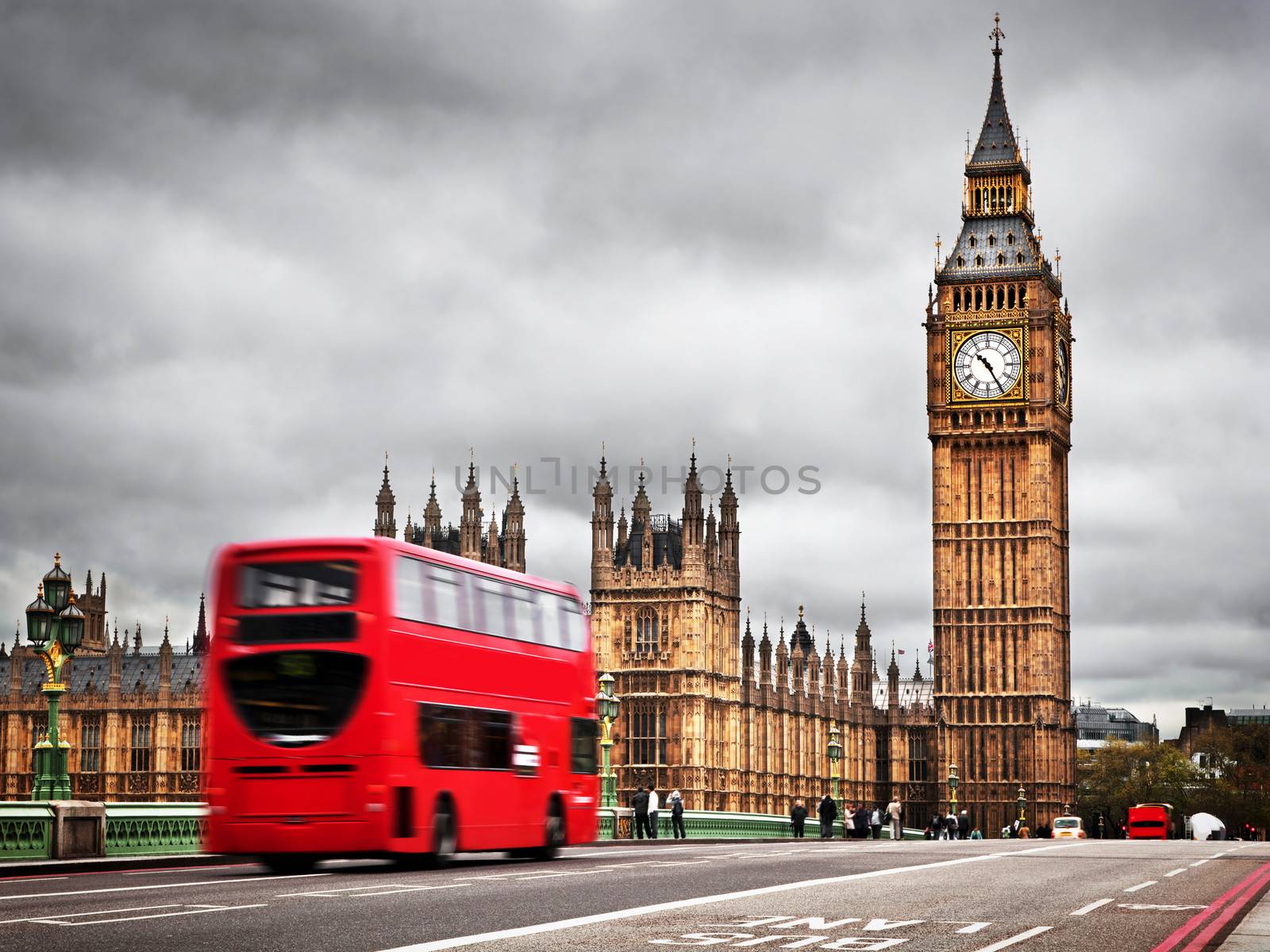London, the UK. Red bus in motion and Big Ben, the Palace of Westminster. The icons of England in vintage, retro style