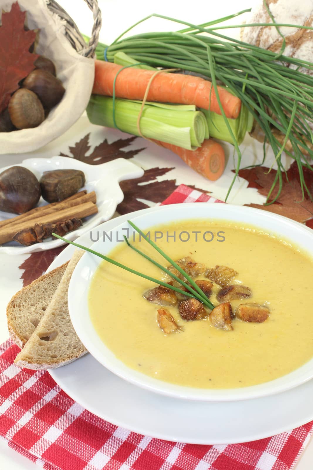 a bowl of sweet chestnut soup with roasted chestnuts and chives