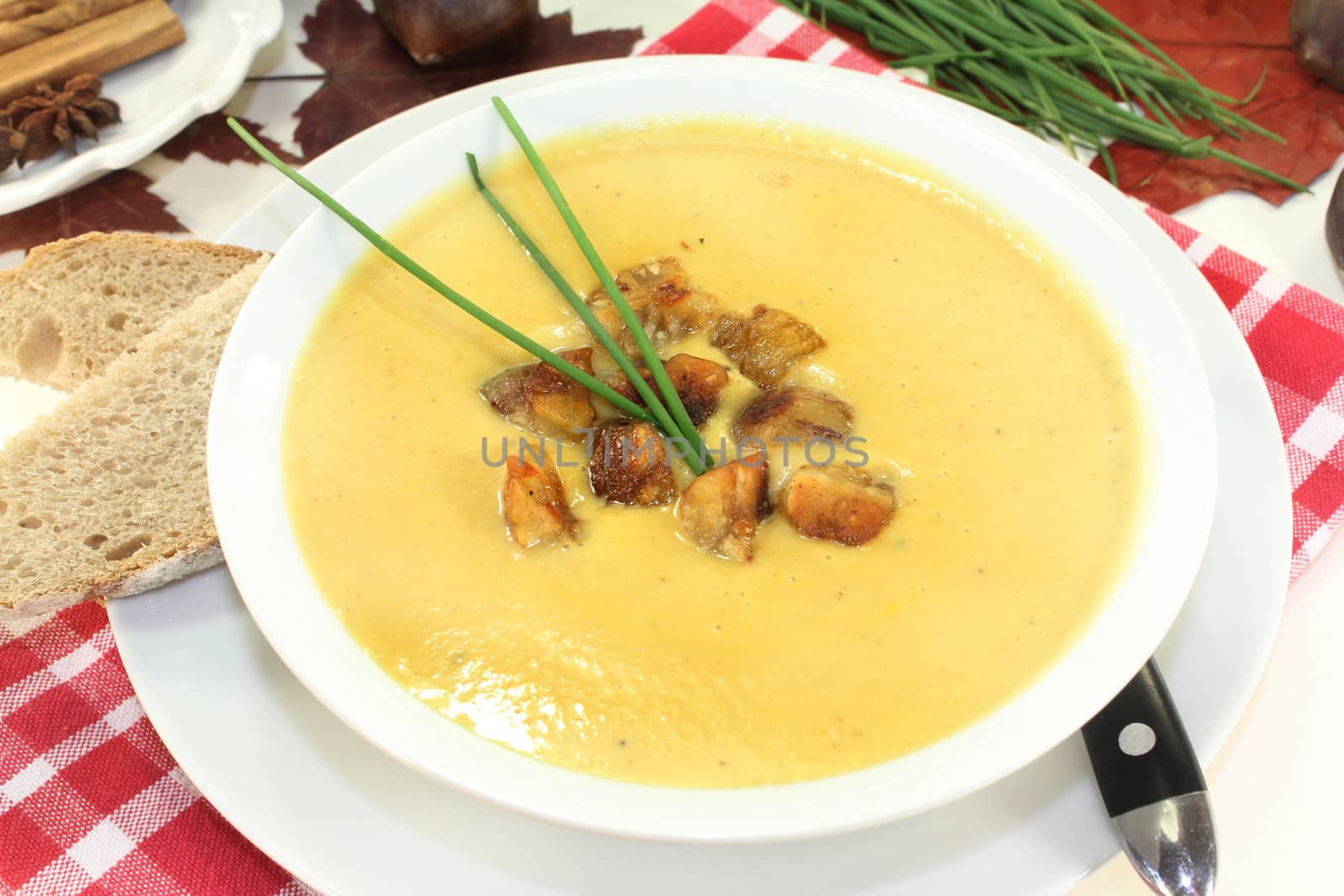 a bowl of sweet chestnut soup with roasted chestnuts and chives