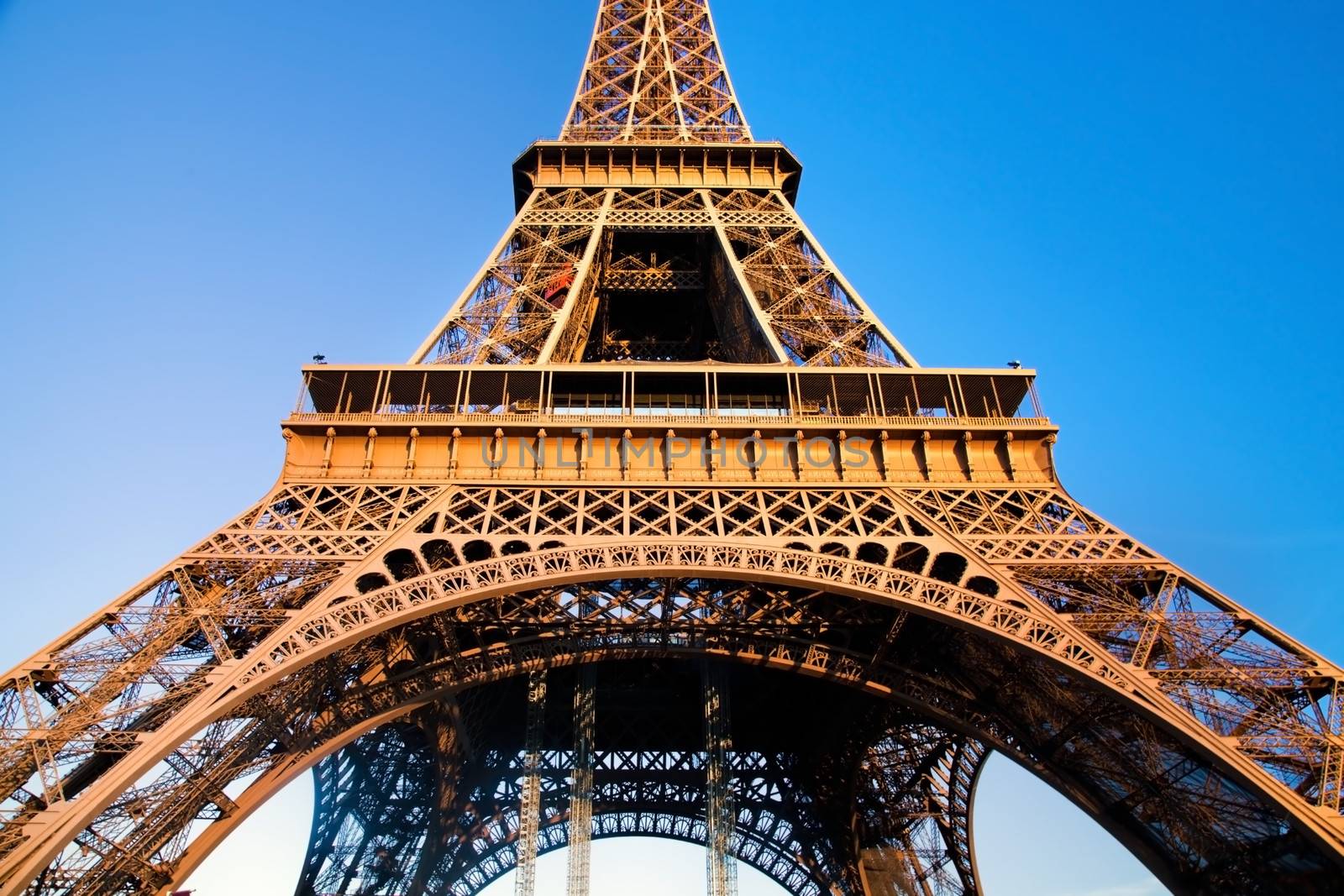 Eiffel Tower at wide angle. Middle section Blue sunny sky. Paris, France