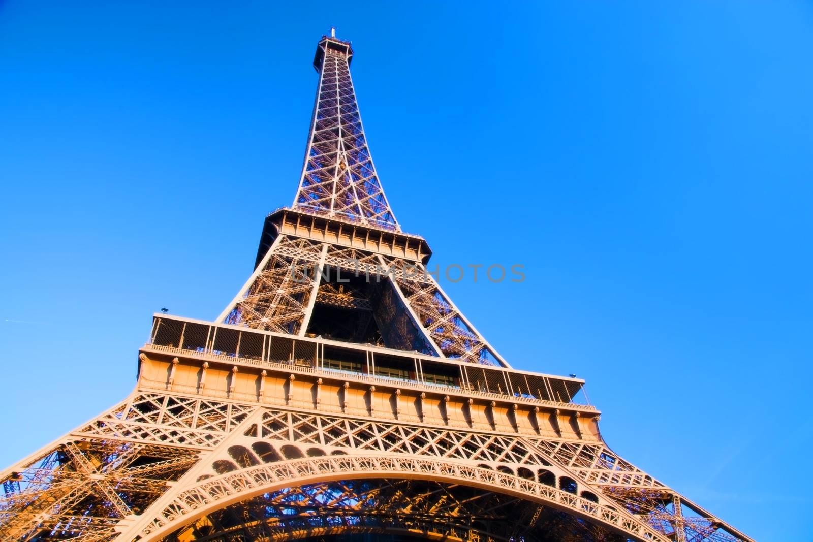 Eiffel Tower at wide angle. Blue sunny sky. Paris, France