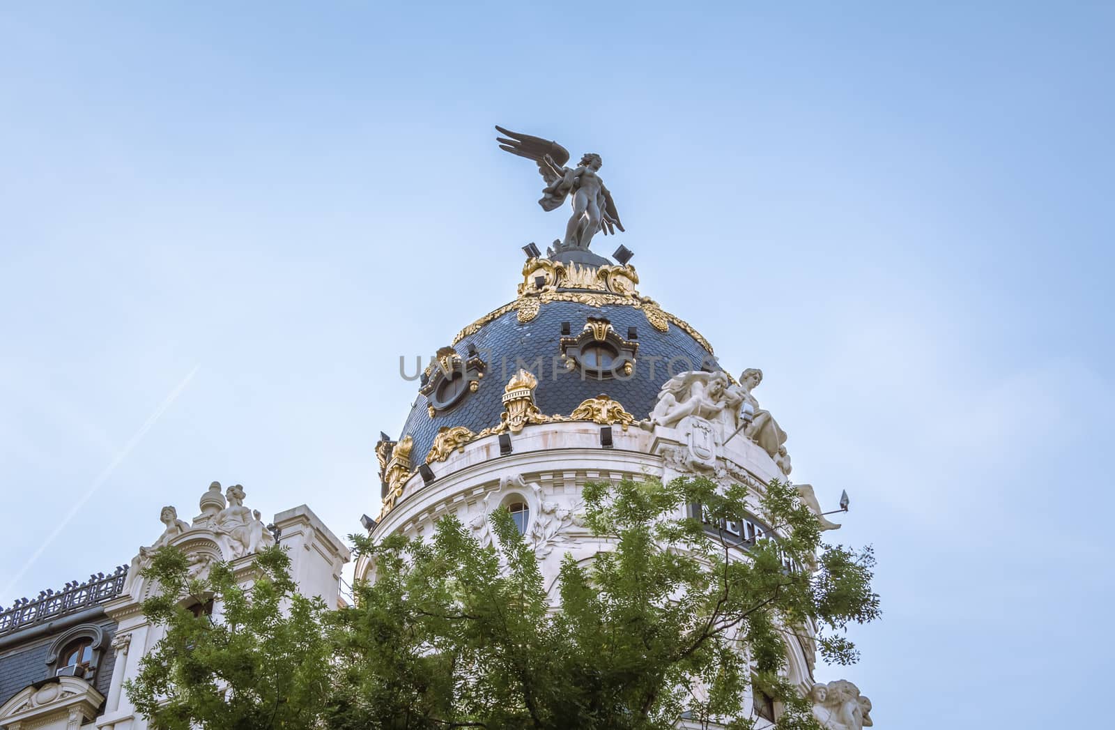 Dome closeup of famous Metropolis building in Gran Via street, in Madrid, Spain