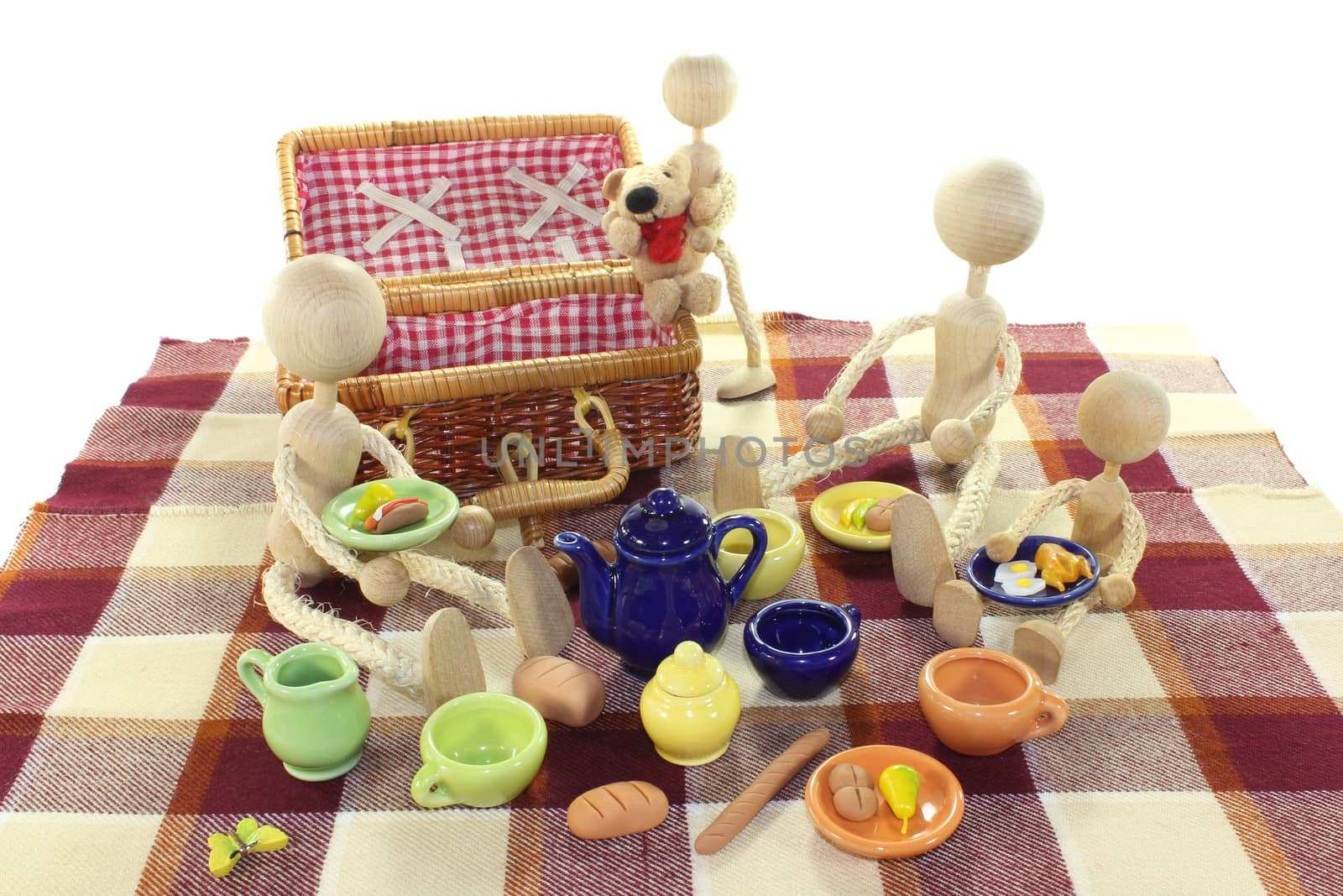 Picnic with family, wicker basket, blanket and dishes on a light background