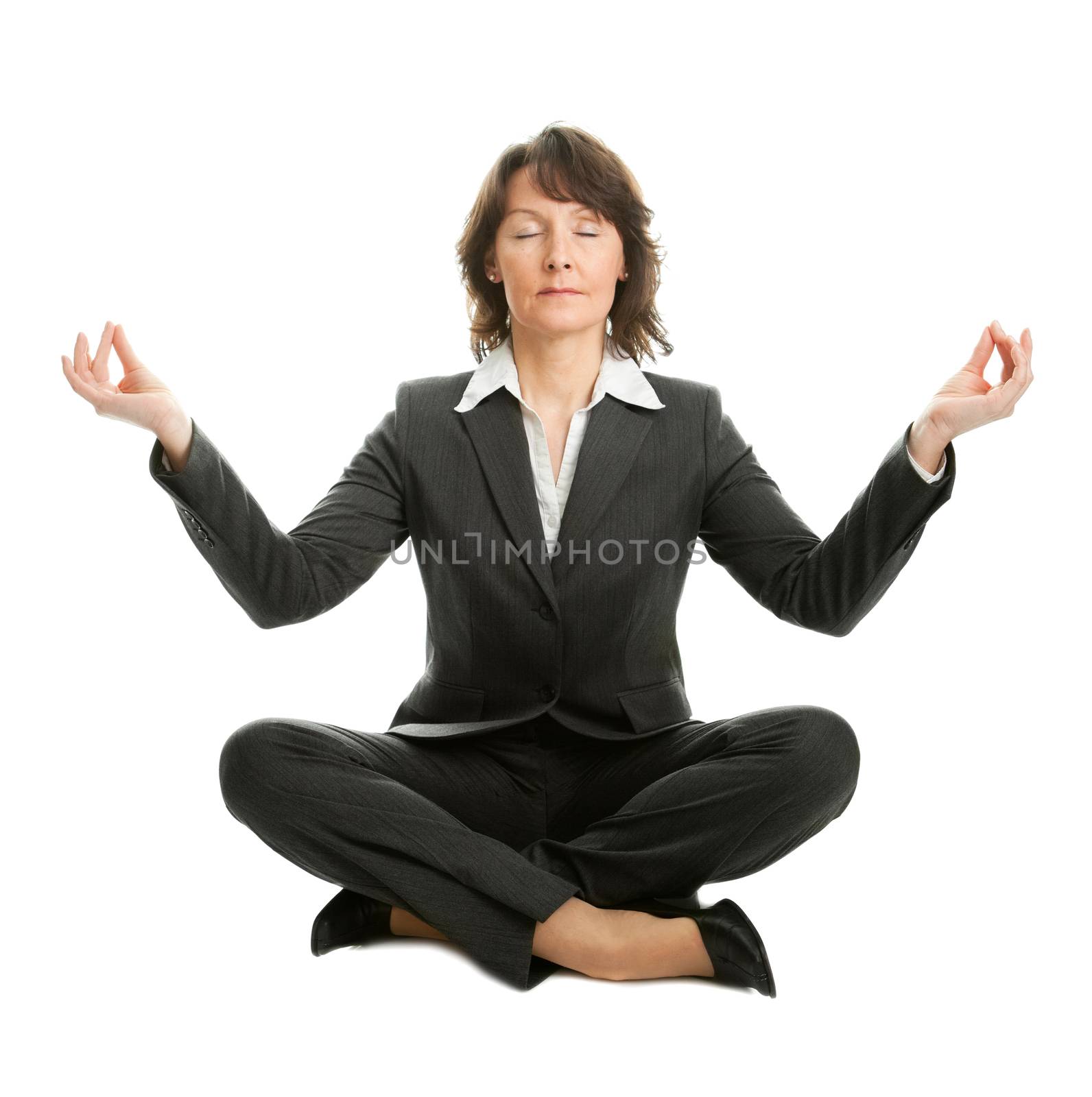 Businesswoman sitting in lotus flower position of yoga. Isolated on white