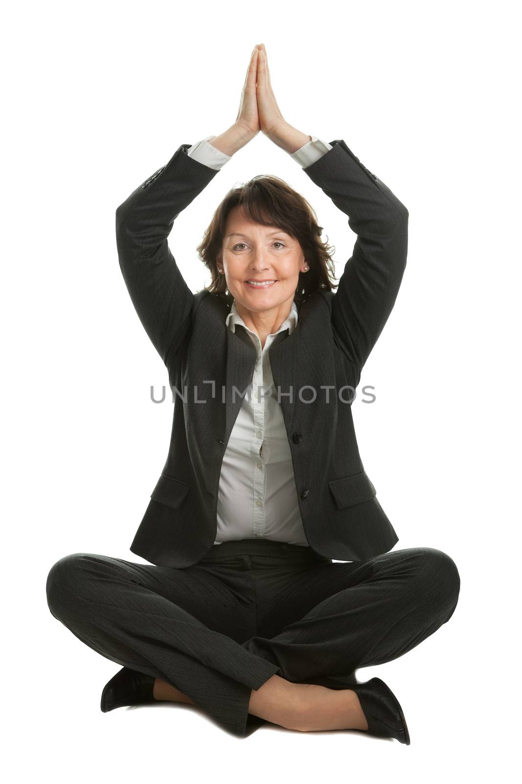 Businesswoman sitting in lotus flower position of yoga. Isolated on white