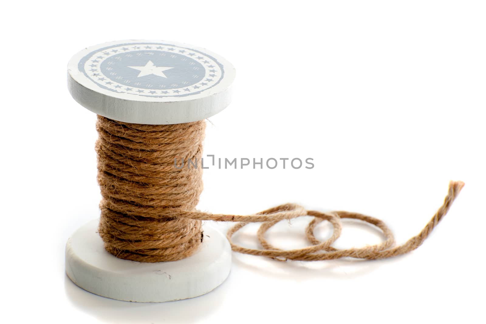 a spool of rope in the color brown on a white background