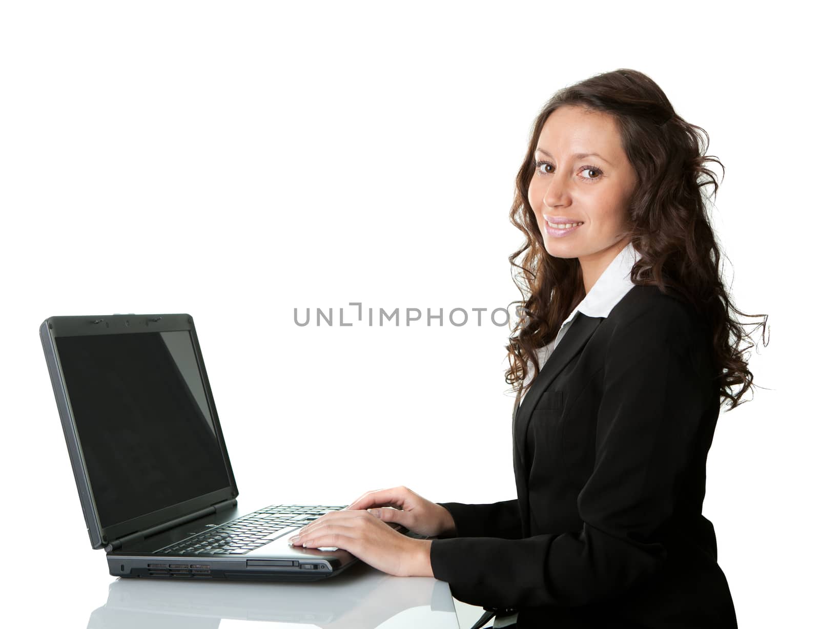 Beautiful business woman working on laptop by AndreyPopov