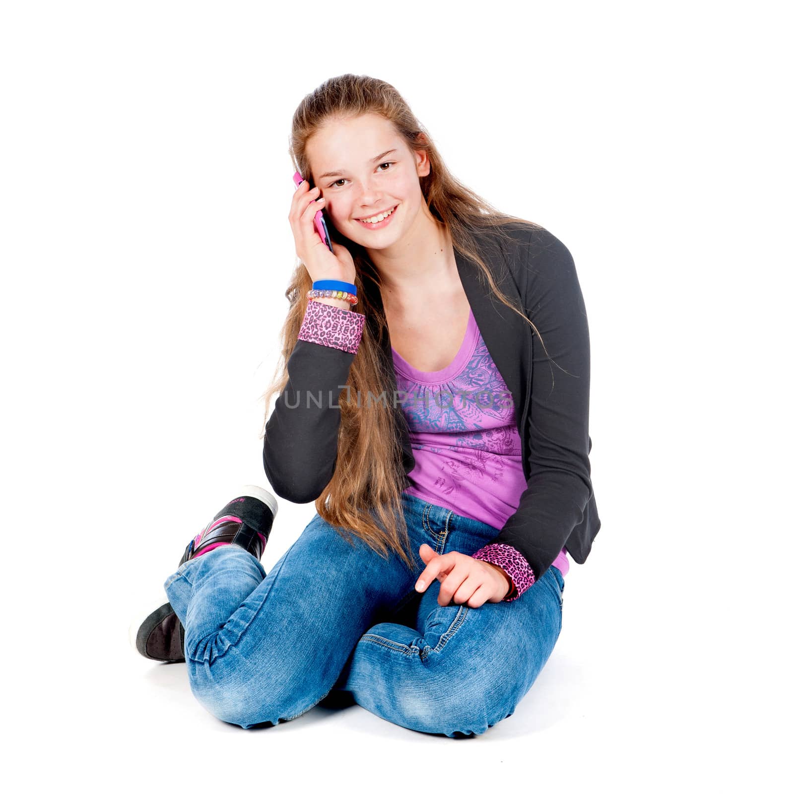 a beautiful young and modern girl with a mobile phone on a white background