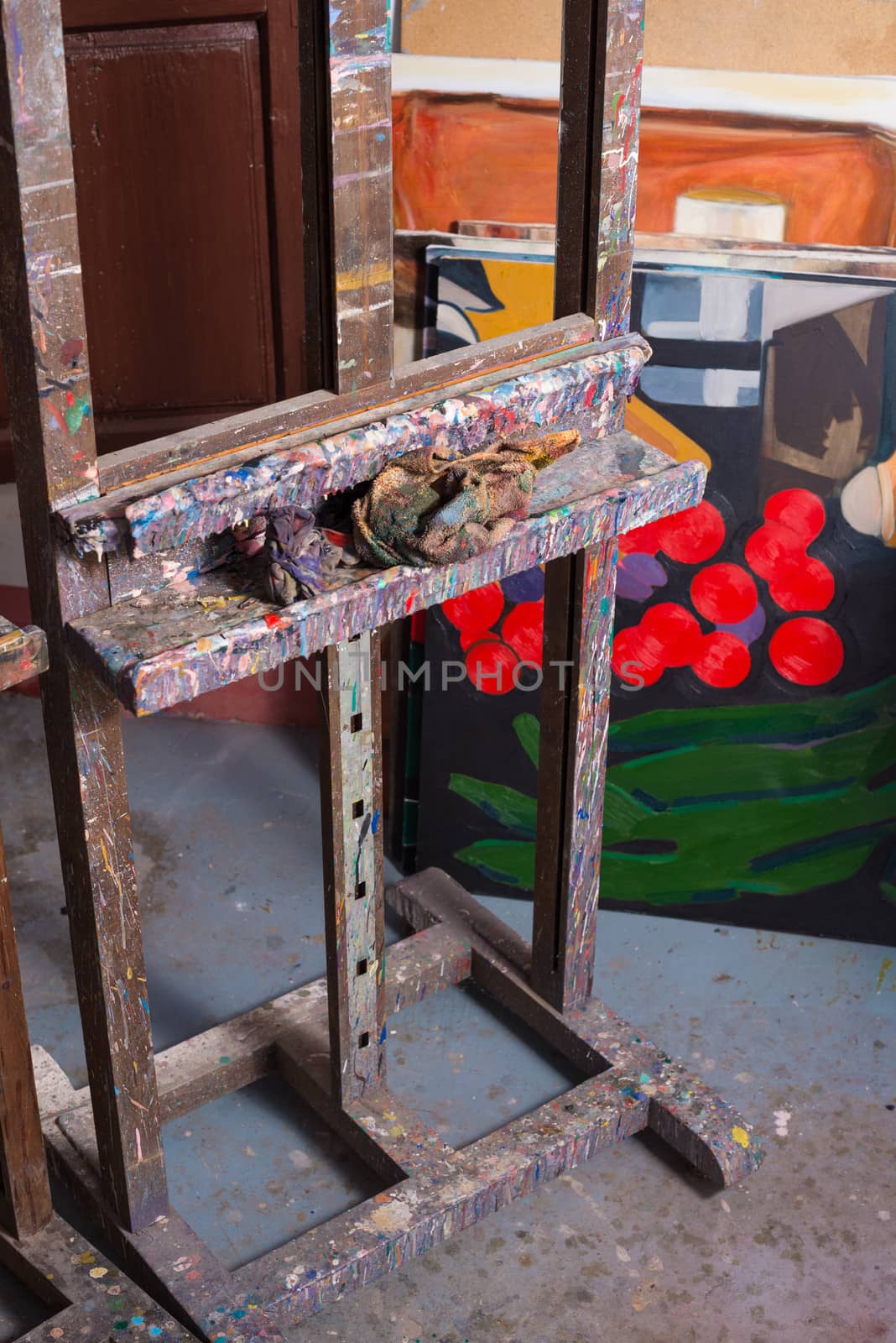 Easel surrounded by objects in a painters atelier