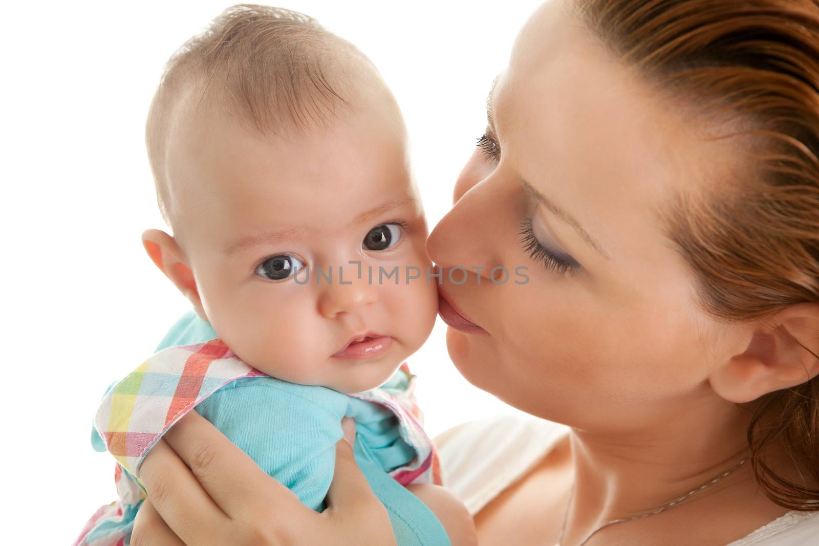 Closeup of loving mother kissing her daughter on cheek