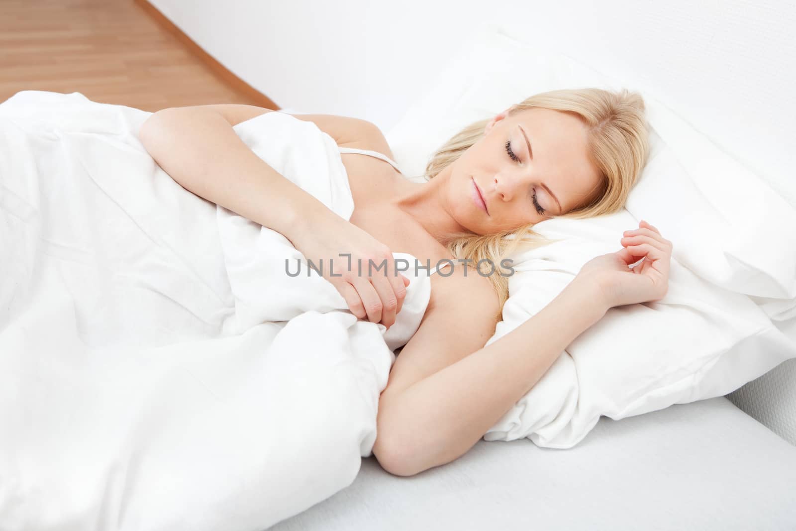 Young beautiful woman sleeping in bed at home