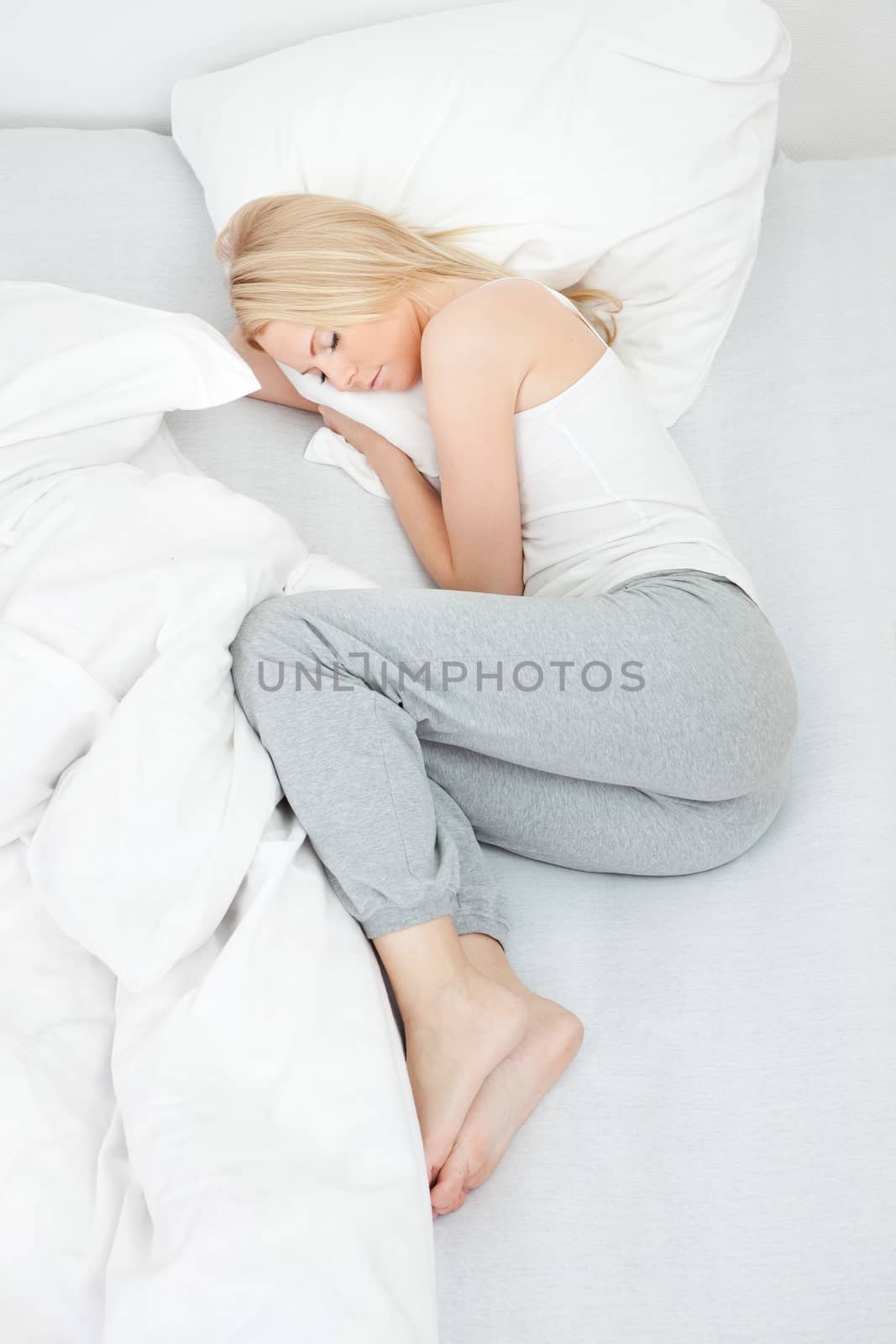 Young beautiful woman sleeping in bed at home