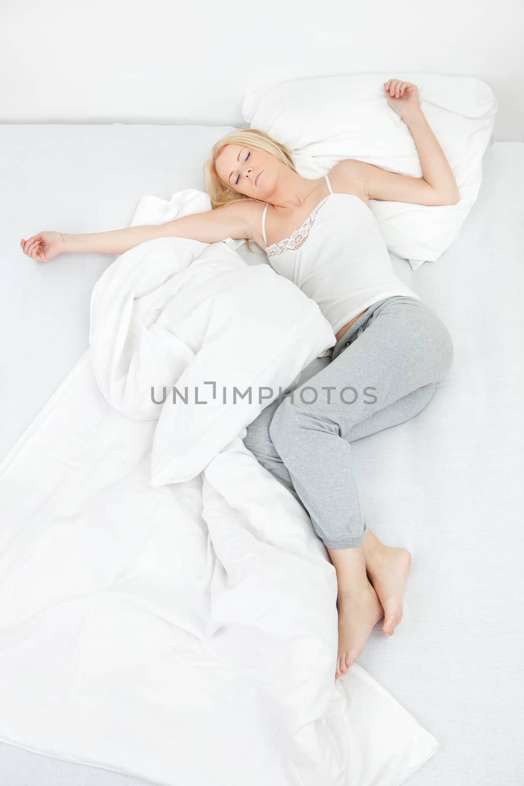 Young beautiful woman sleeping in bed at home