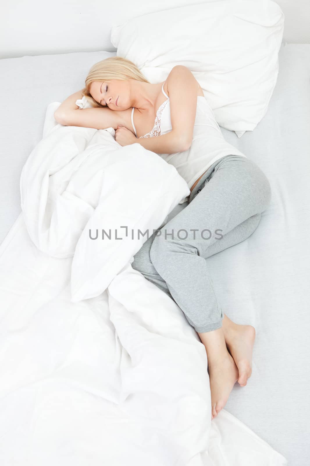 Young beautiful woman sleeping in bed at home