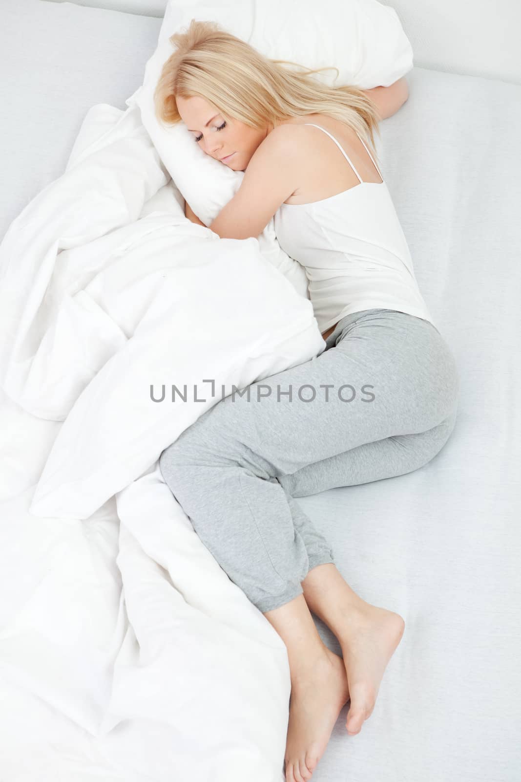 Young beautiful woman sleeping in bed at home