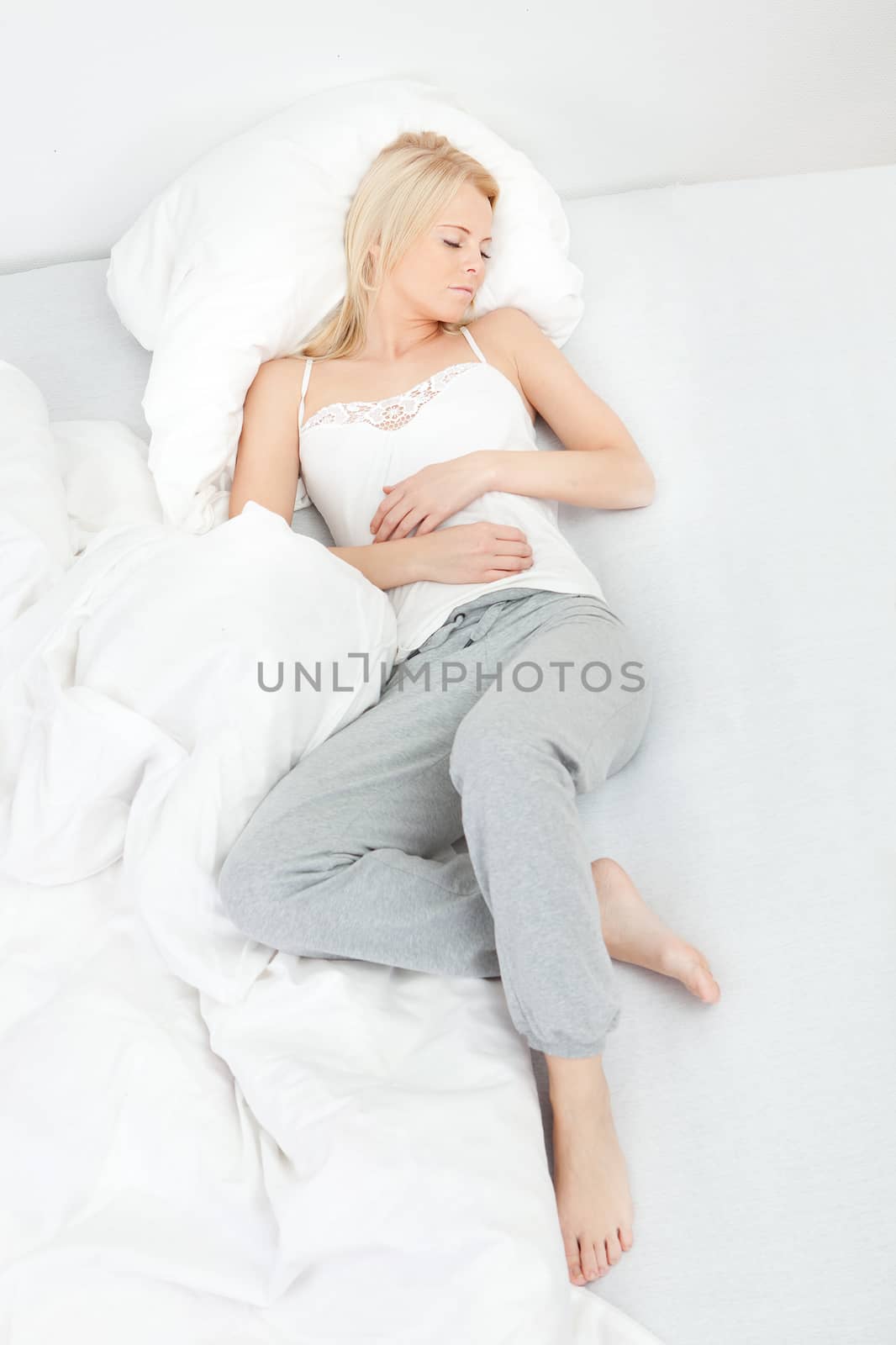 Young beautiful woman sleeping in bed at home