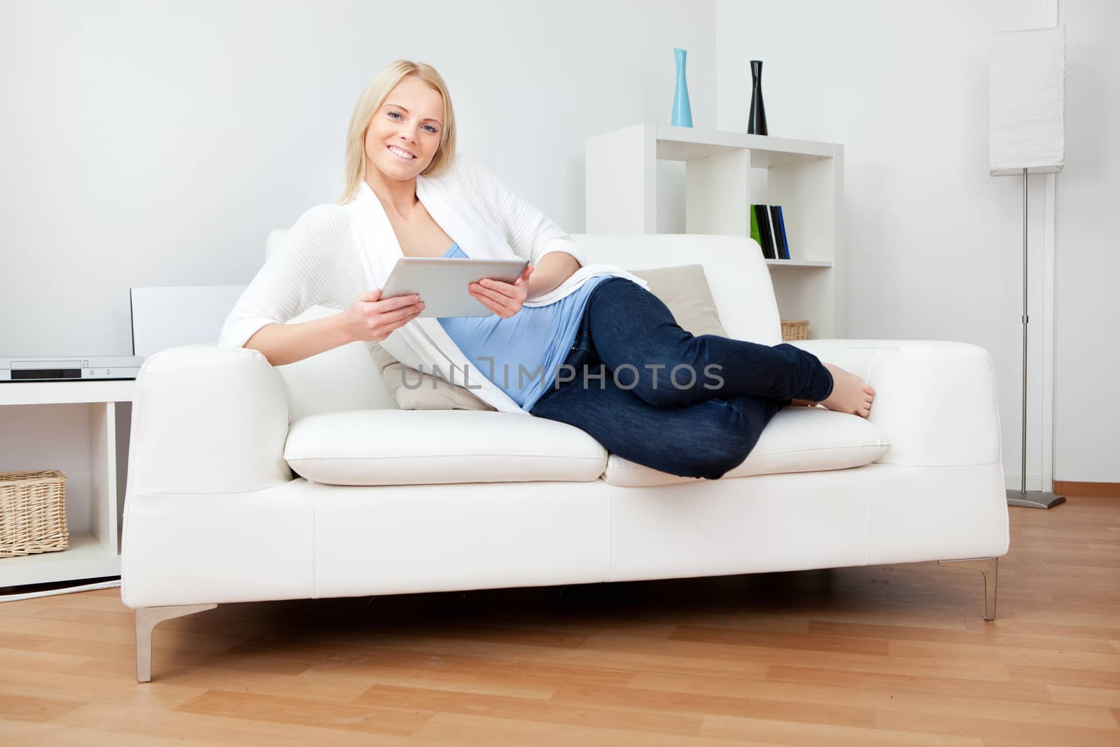 Beautiful woman working on computer sitting in sofa